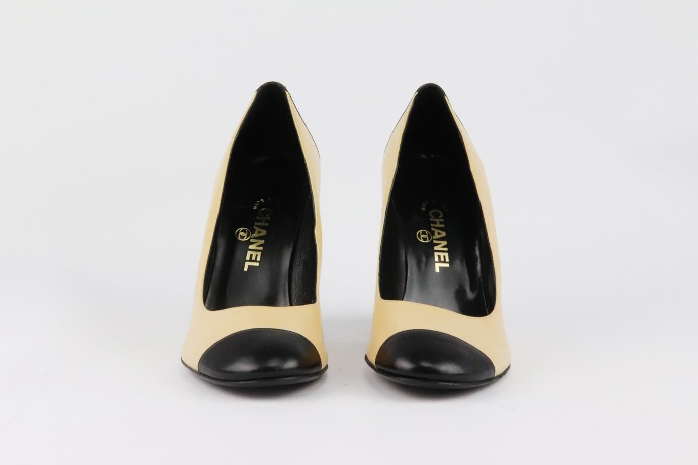 These pumps by Chanel have been made in Italy from beige and black leather, they're set on a block heel that's balanced with a rounded toe. Heel measures approximately 76 mm/ 3 inches. Black and beige leather. Slip on. Does not come with box or