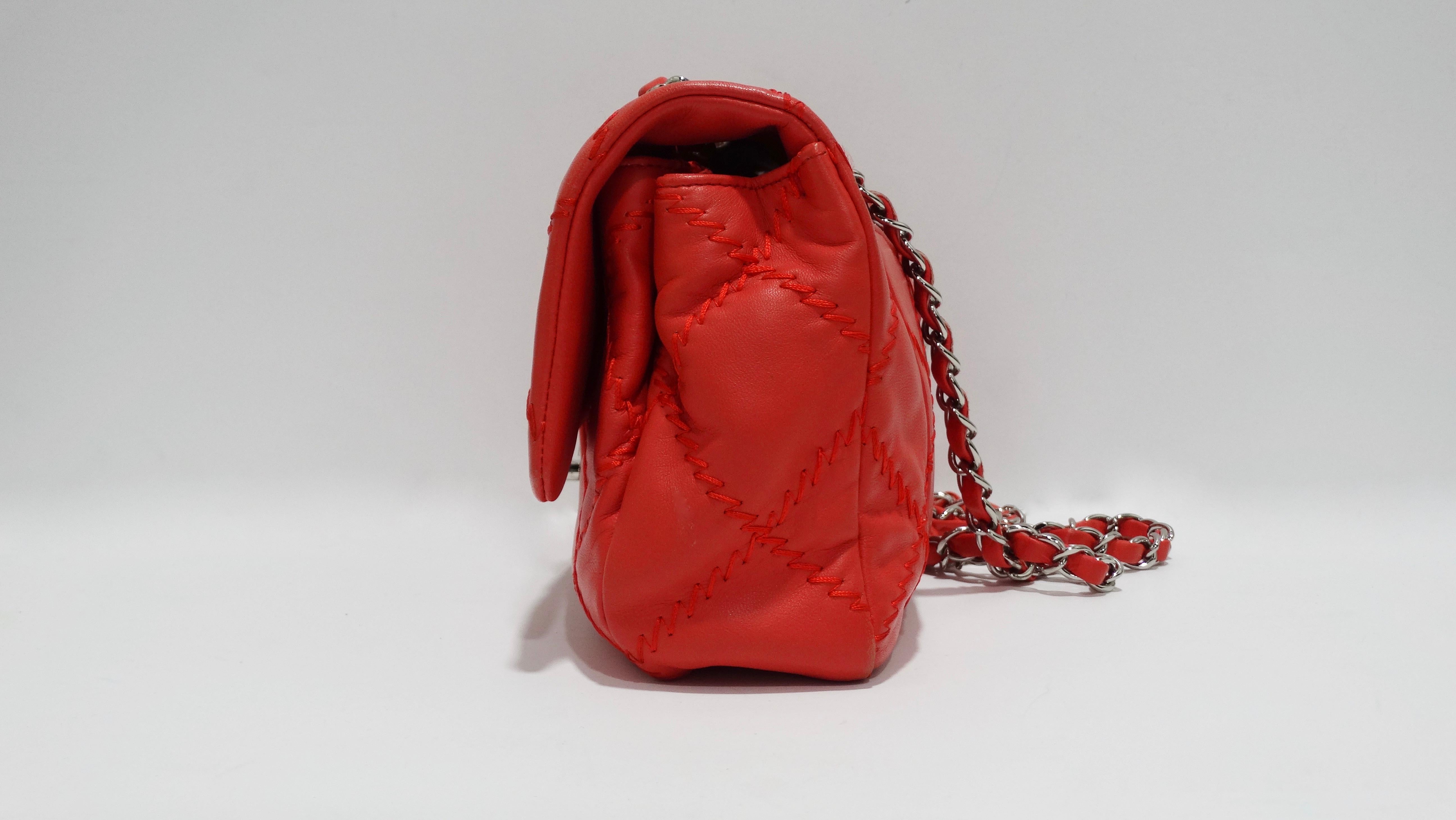 Add some color to your look with this amazing Chanel! Circa 2011, this ultimate stitch single flap is crafted from ultra soft red/orange lambskin leather and features tonal exposed stitching, silver hardware, dual leather and chain link straps, and