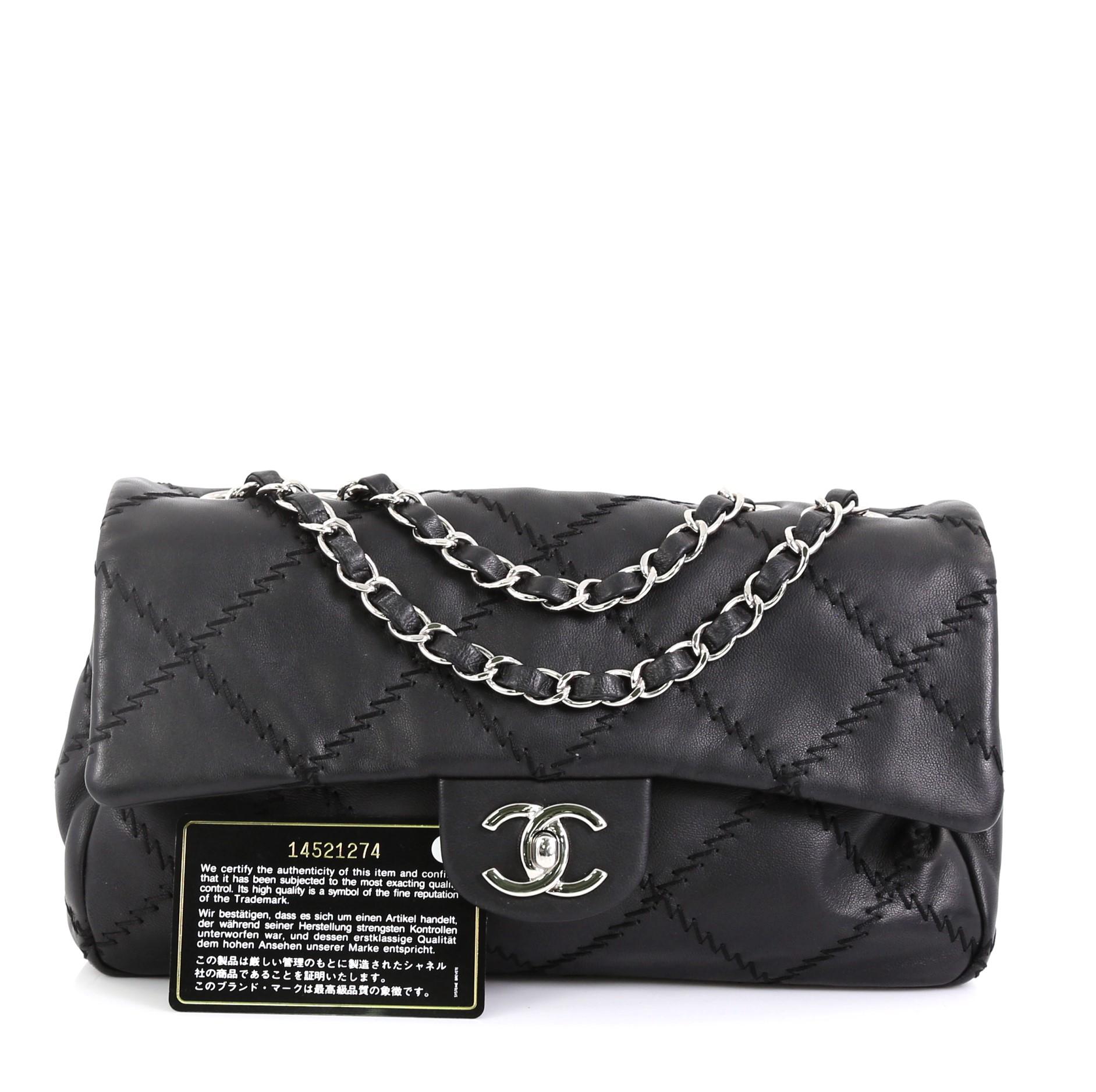 This Chanel Ultimate Stitch Flap Bag Quilted Calfskin Medium, crafted from black quilted leather, features dual woven-in leather chain straps, wide zigzag stitching throughout, CC turn-lock, exterior back pocket and silver-tone hardware accents. Its