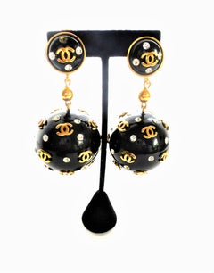 Unique Vintage Chanel black big ball clip on earrings, plastic 1970s with gold