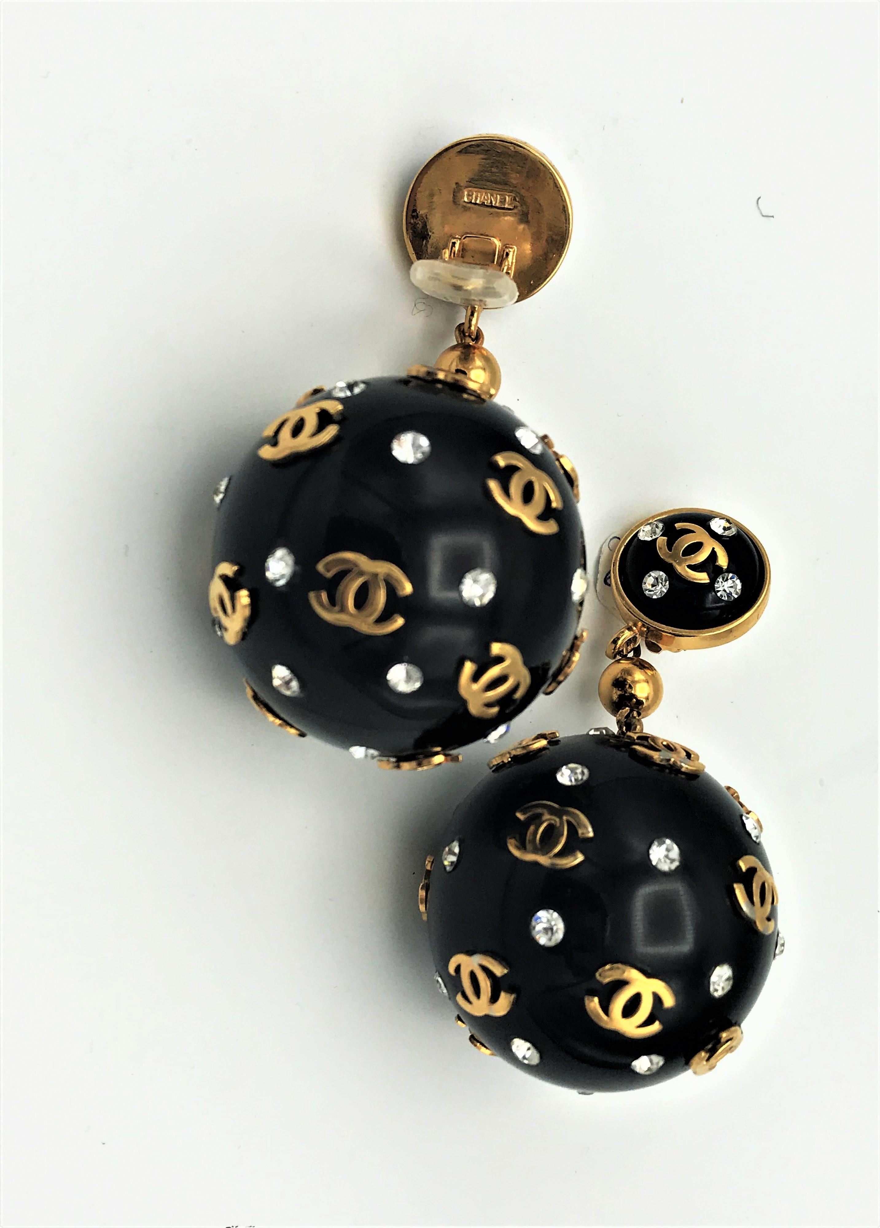 Women's Unique Vintage Chanel black big ball clip on earrings, plastic 1970s with gold