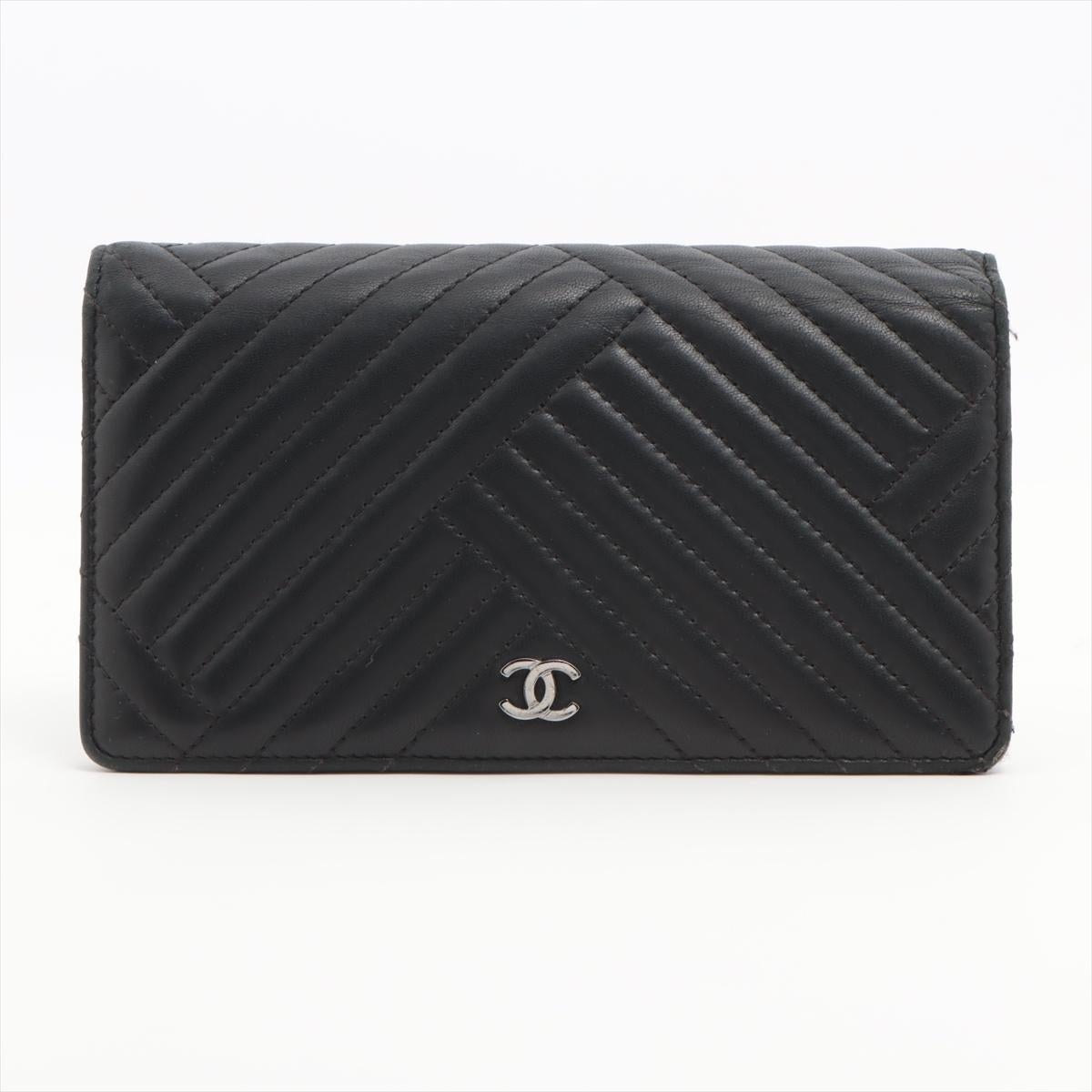 The Chanel V Stitch Lambskin Wallet in Black is an epitome of refined elegance and luxury. Crafted from sumptuous lambskin leather, the wallet features a meticulously stitched V-shaped pattern, adding a distinctive and tactile dimension to its