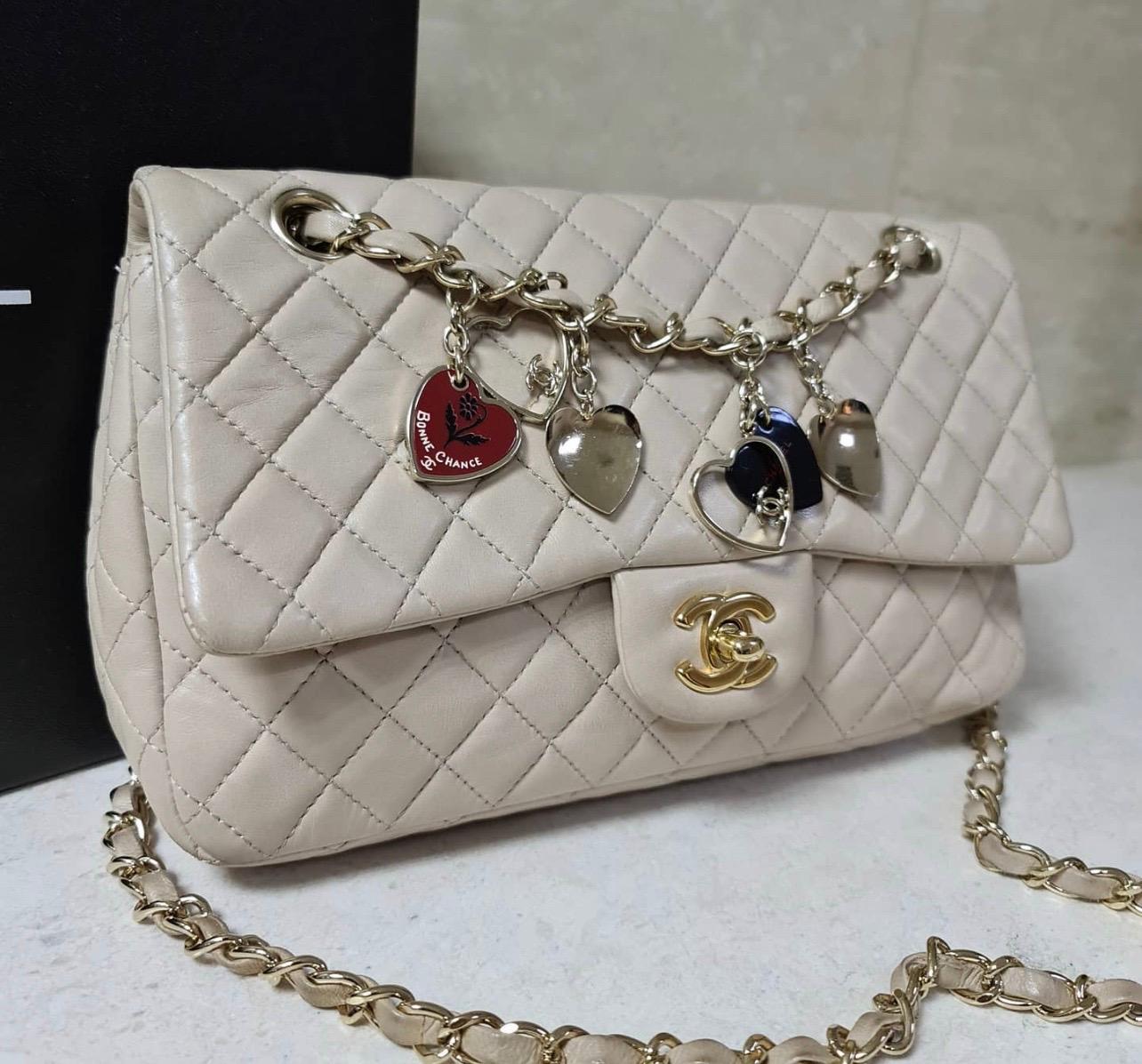 This is a Medium Classic Chanel flap bag and is from the Valentine Collection 2010. 
The bag has a single flap and has the color beige. 
The material of the bag is lambskin, so the bag is very sensitive to dark clothes and bad weather. 
24*14*6