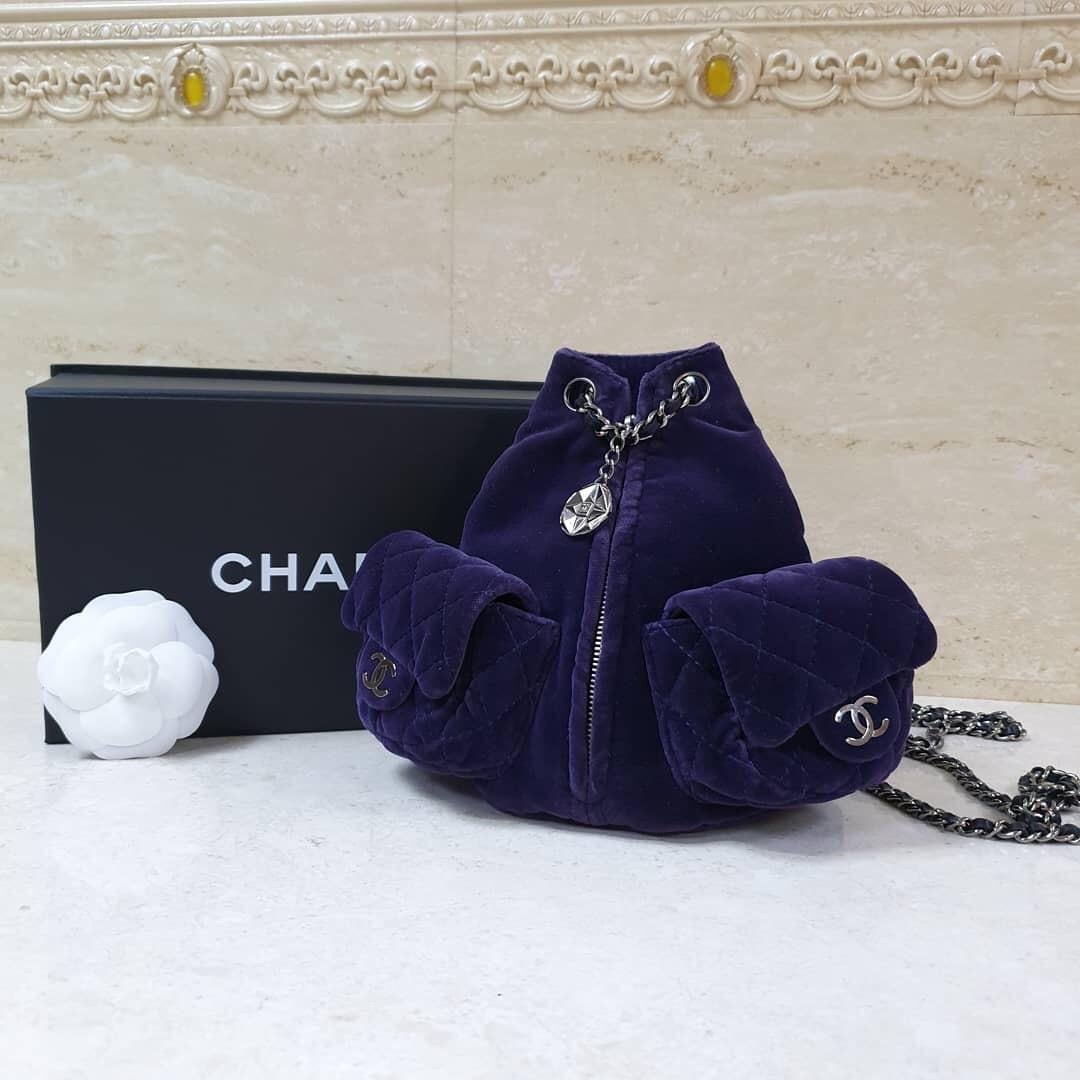 This is a rare, limited edition CHANEL Velvet Mini Backpack Is Back in Plum. This stylish backpack is crafted of a luxe velvet in a rich shade of purple.



The pack features two structured diamond quilted external pockets  with interlocking CC