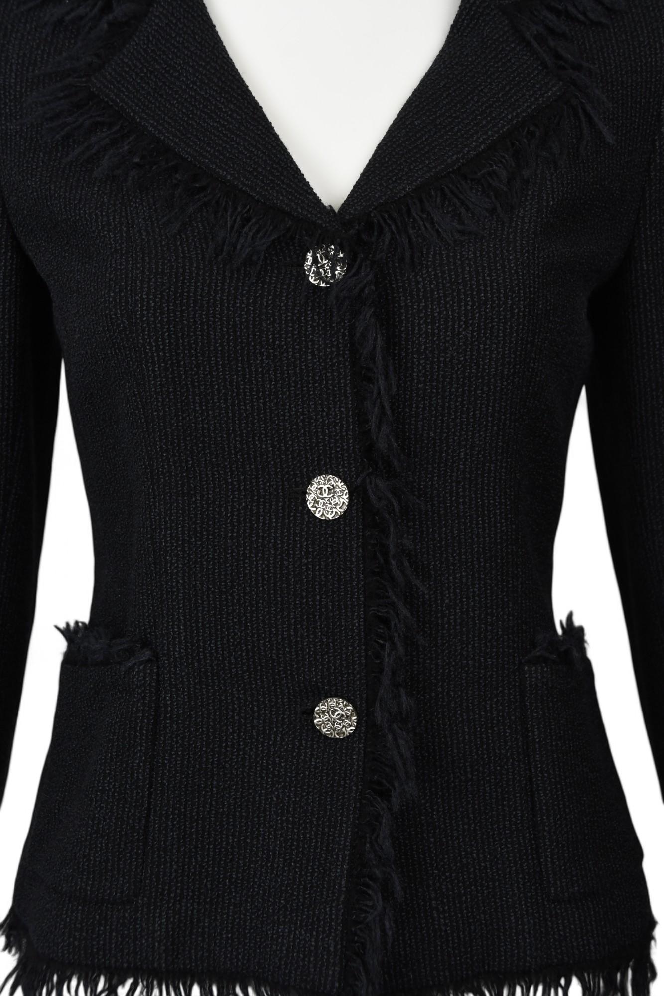 his timeless black tweed blazer from Chanel’s 2004 Spring Collection (04P) exudes refined sophistication with a modern twist. Crafted from a structured wool-blend knit, the jacket features tonal fringe trimming along the lapel, cuffs, hemline, and