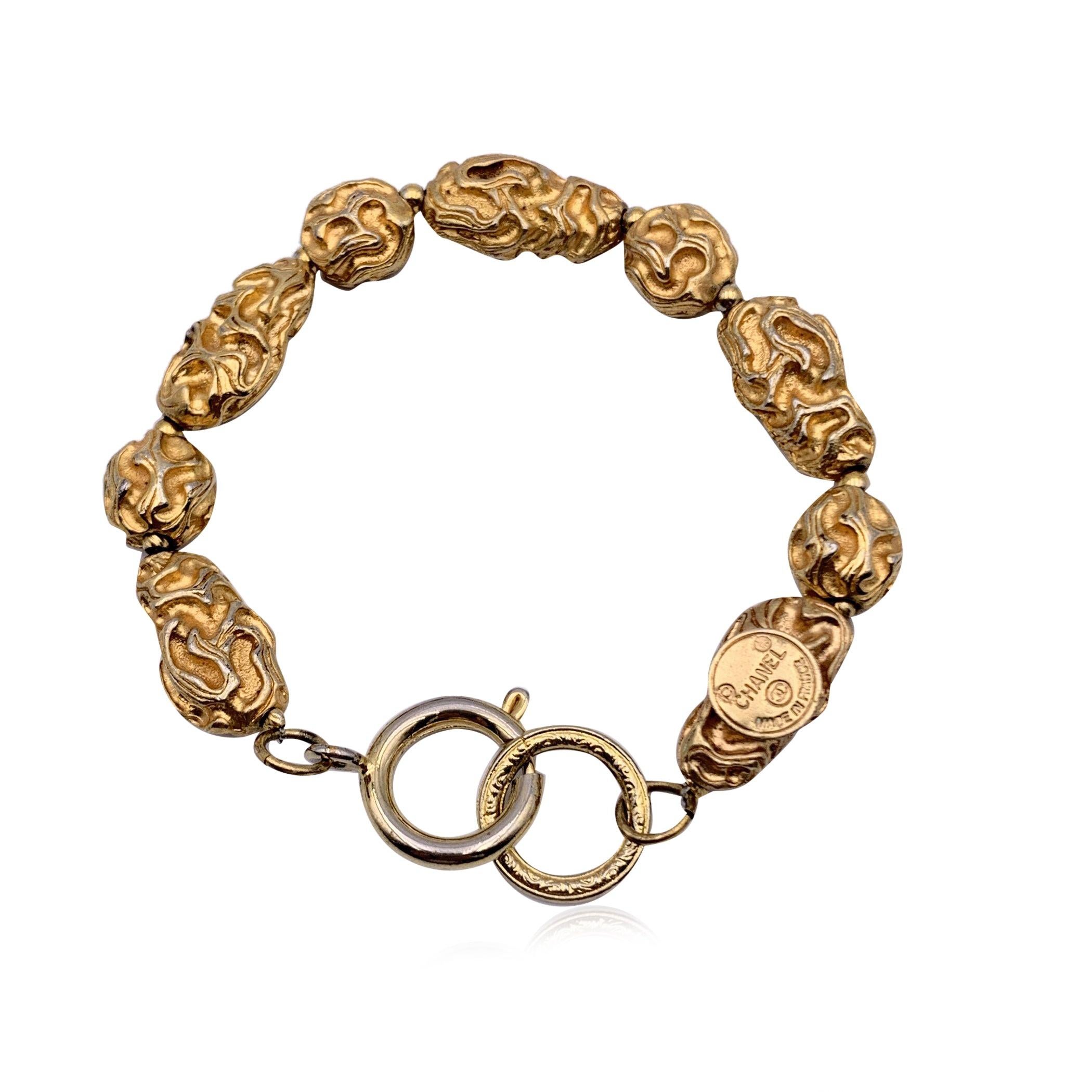 Beautiful vintage bracelet from the 70s by CHANEL. Irregulared engraved gold metal pieces. Spring ring closure. 'CHANEL CC Made in France' round hallmark at the end of the bracelet. Total length: 7.5 inches - 19 cm Condition B - VERY GOOD Gently