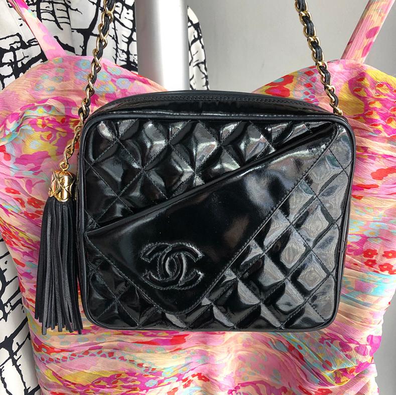 Chanel Vintage 1989 Black Patent CC Quilt Camera Bag.  Black patent leather body with CC fold over flap at front, black lambskin leather piping and tassel.  Gold braided chain strap. Date code 1-series for production year 1989-1991. Measures 8 x 6.5