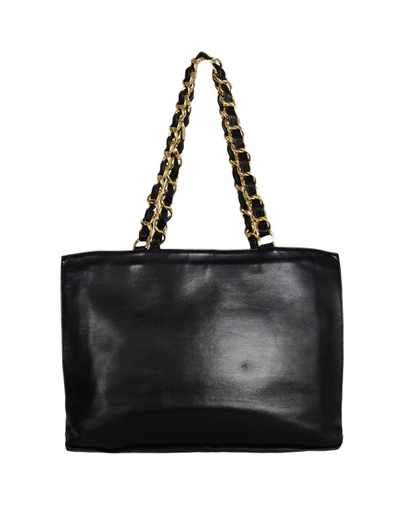 Chanel Black Lambskin CC Tote Bag. Features gold tone leather laced heavy chain strap

Made In: France
Year of Production: 1990s
Color: Black
Hardware: Gold tone
Materials: Lambskin leather, metal
Lining: Black leather
Closure/Opening: Open