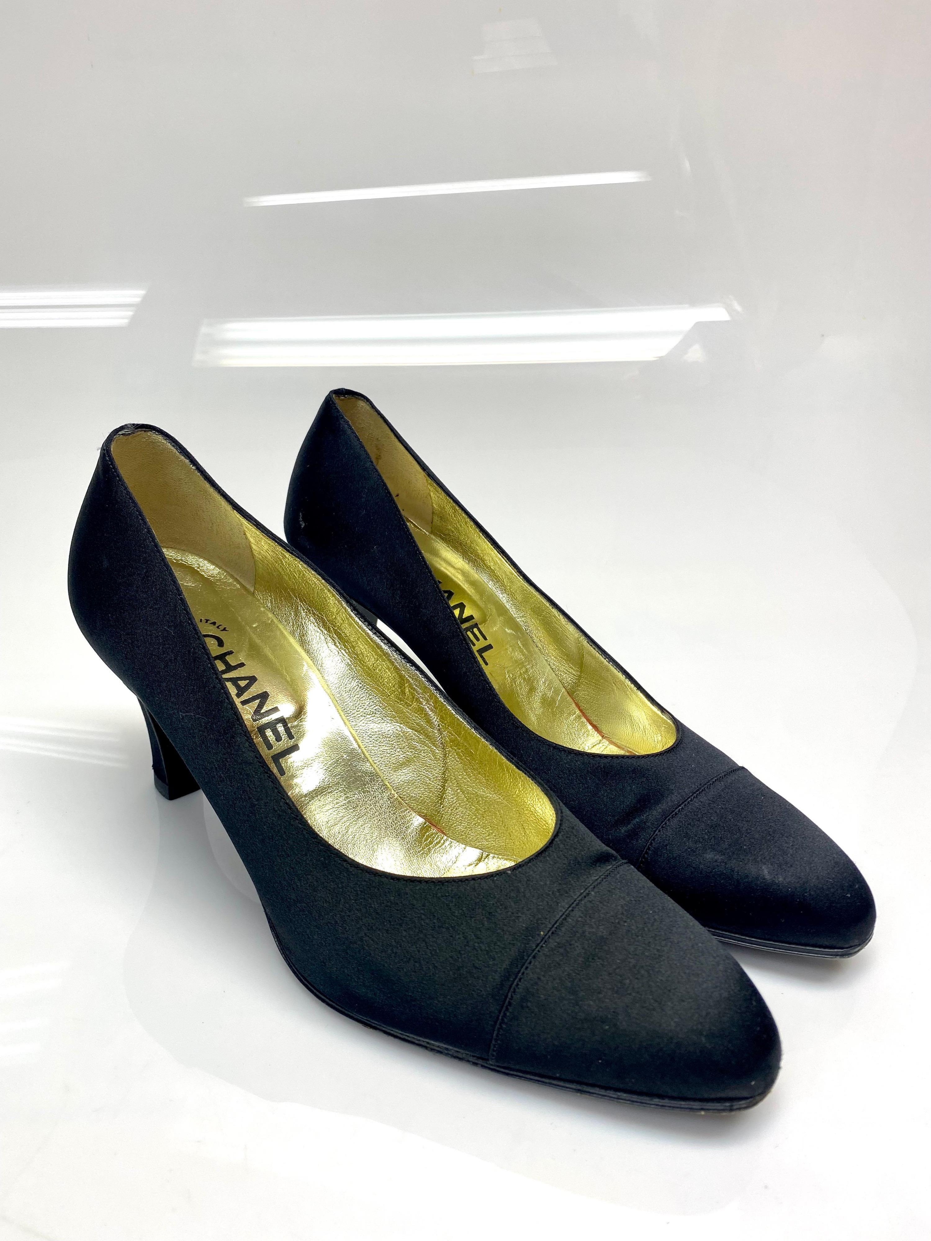 Chanel Vintage Black Satin Pumps Size 38.5. These 1990’s timeless vintage pumps by Chanel are absolutely stunning. The black satin and rounded toe gives the pump a sophisticated look. Item is in good condition with some marks on the satin