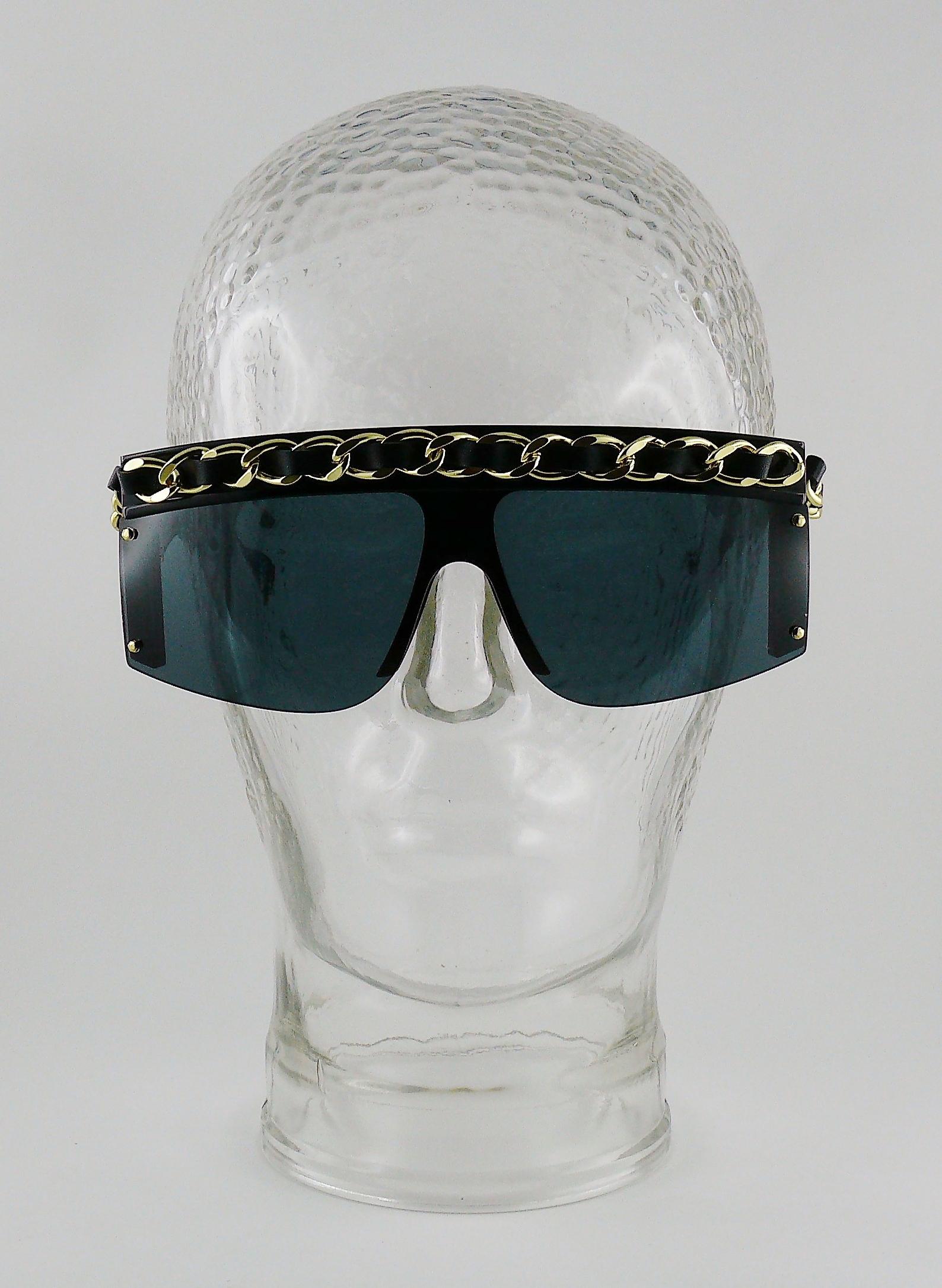 **** WE NO LONGER SHIP SUNGLASSES TO THE USA ****

CHANEL vintage black sunglasses featuring iconic leather and chain accross the frame and temples.

As seen on LADY GAGA.

Marked CHANEL Made in Italy 0026 90.

Indicative measurements : width