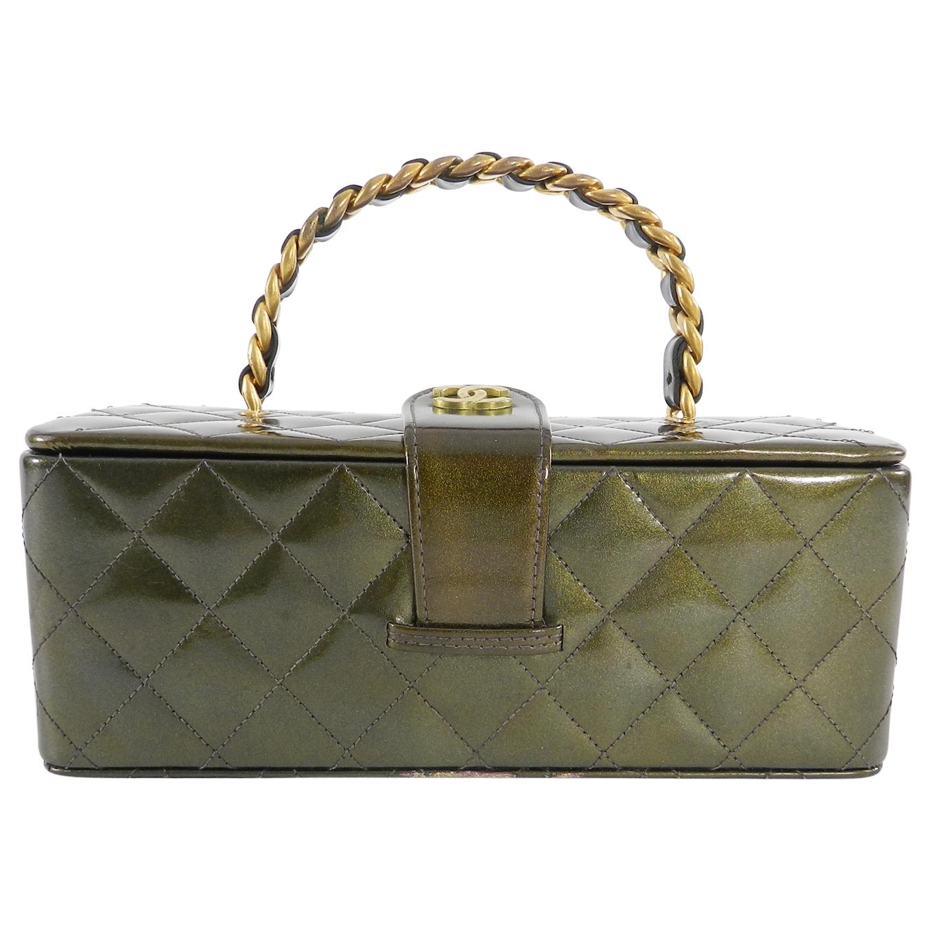 Chanel Vintage 1994 Olive Green Patent Vanity Case Bag.  True vintage limited edition box bag.  Olive green quilted patent leather body with antiqued brass rigid chain handle and CC logo snap closure.  Black leather lined interior with mirror top