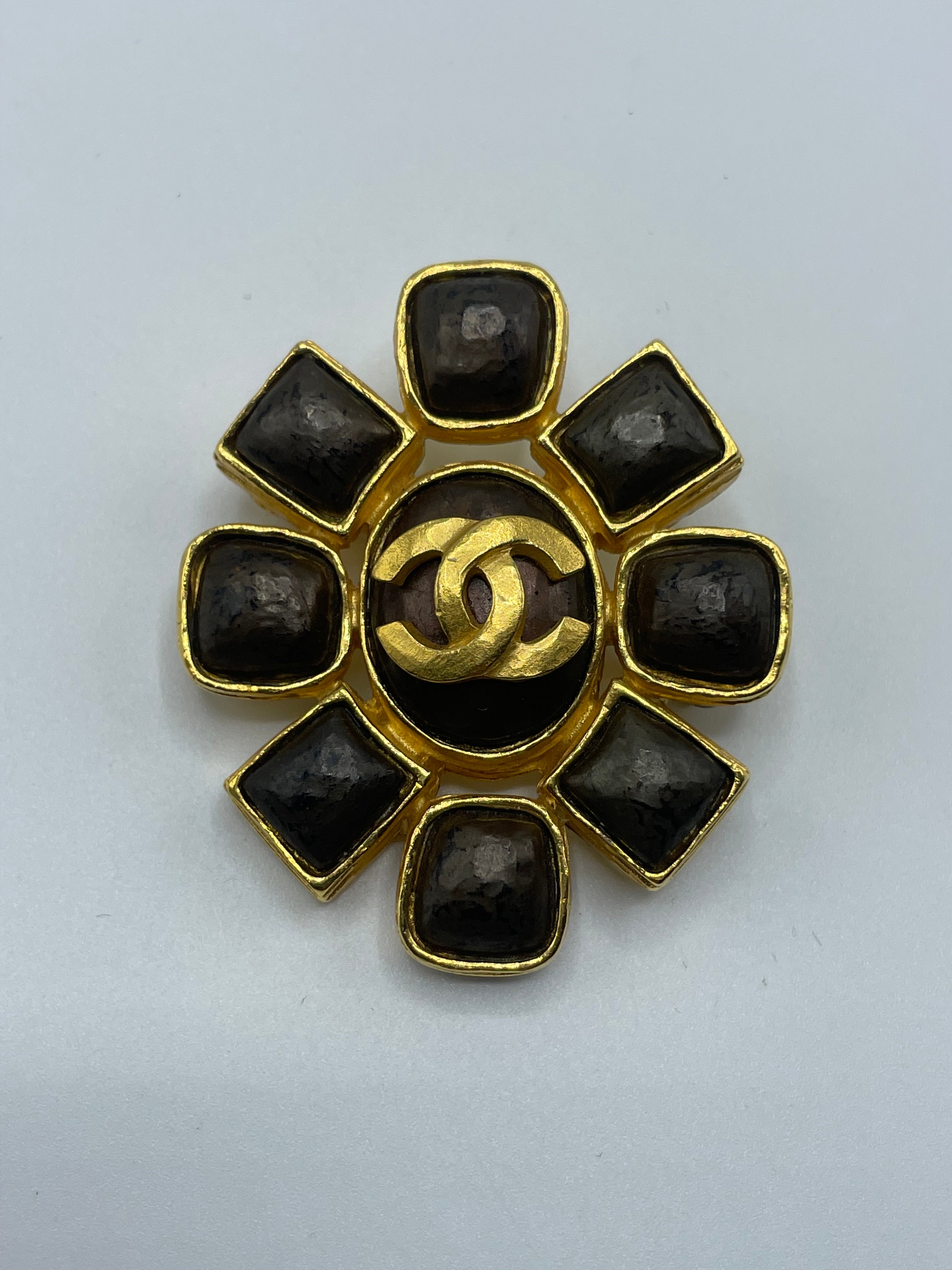 Chanel brooch from the 1997 gold plated. In wonderful vintage condition, with a large CC in the center and a plethora of round and square shapes surrounding it. Signed Chanel on the reverse. Made in France . 