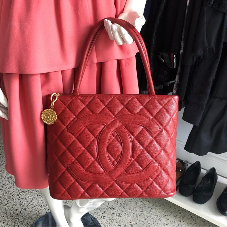 Chanel Red Caviar CC Medallion Tote Bag.  Double handles, zippered top, gold CC medallion chain zipper pull.  Caviar leather with CC logo at front. Date code 5-series for production year 1997-1999. Measures about 12 x 9.5 x 6” with a 6.5” handle
