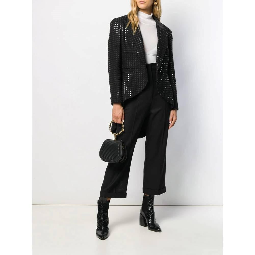Chanel 2000s black wool blend open frock jacket. Notched lapels collar, long sleeves, buttoned cuffs and asymmetric hem. All-over sequins embellishment.

Size: 46 IT

Flat measurements
Front height: 62 cm
Rear height: 92 cm
Bust: 53 cm
Sleeves: 58