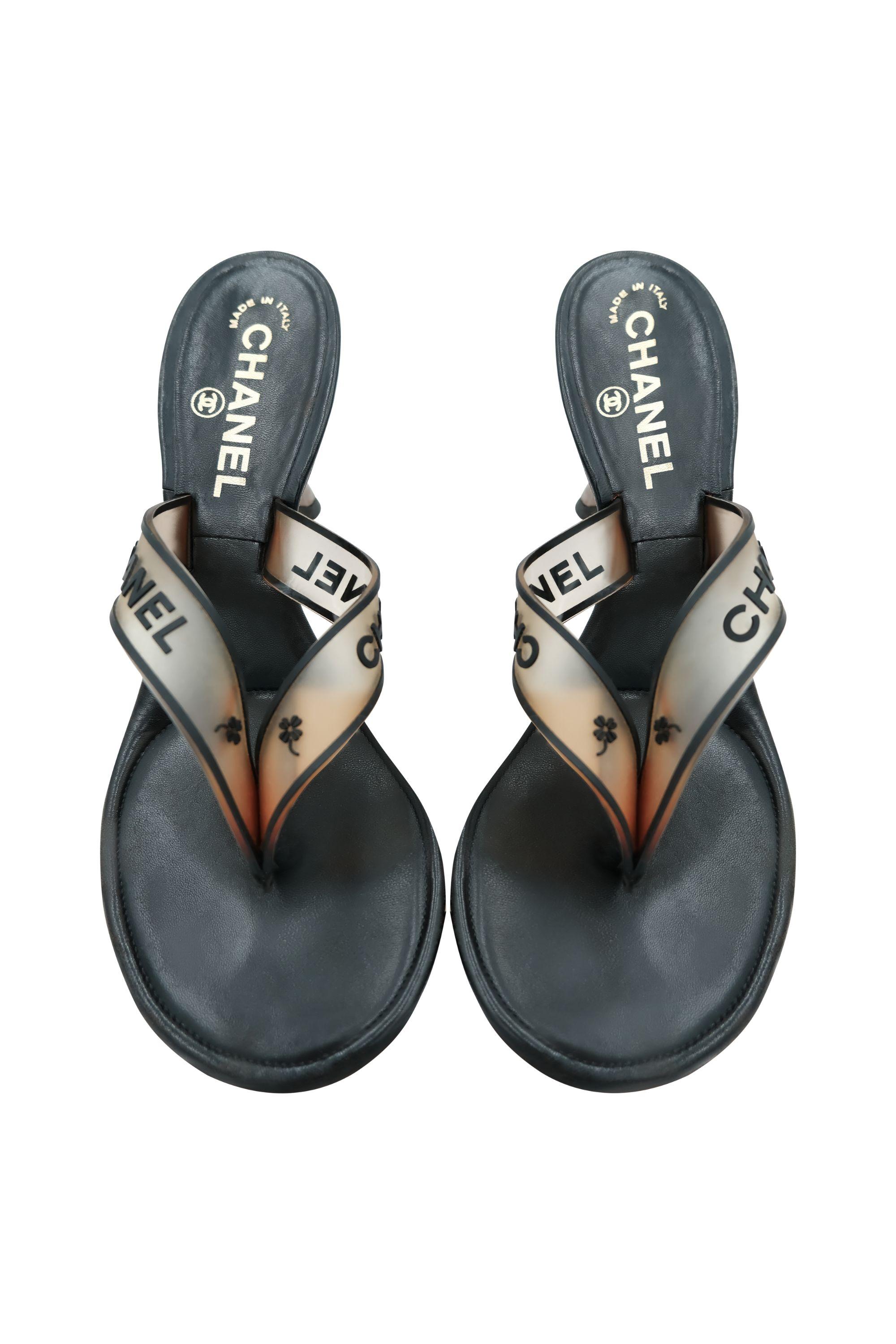 Step into nostalgia with these vintage Chanel rubber thong sandals from the early 2000s. Featuring an elegant black leather footbed, these sandals are adorned with  PVC straps that display the iconic 