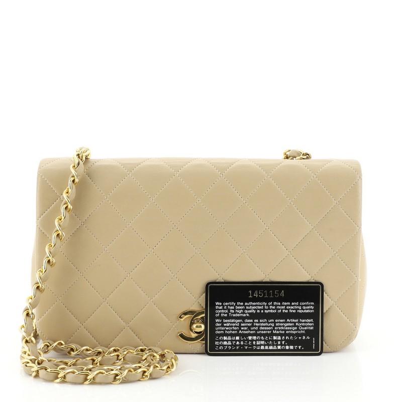 This Chanel Vintage 3 Way Full Flap Bag Quilted Lambskin Small, crafted in neutral quilted lambskin leather, features woven-in leather chain strap and gold-tone hardware. Its CC turn-lock closure opens to a neutral leather interior with zip pocket.