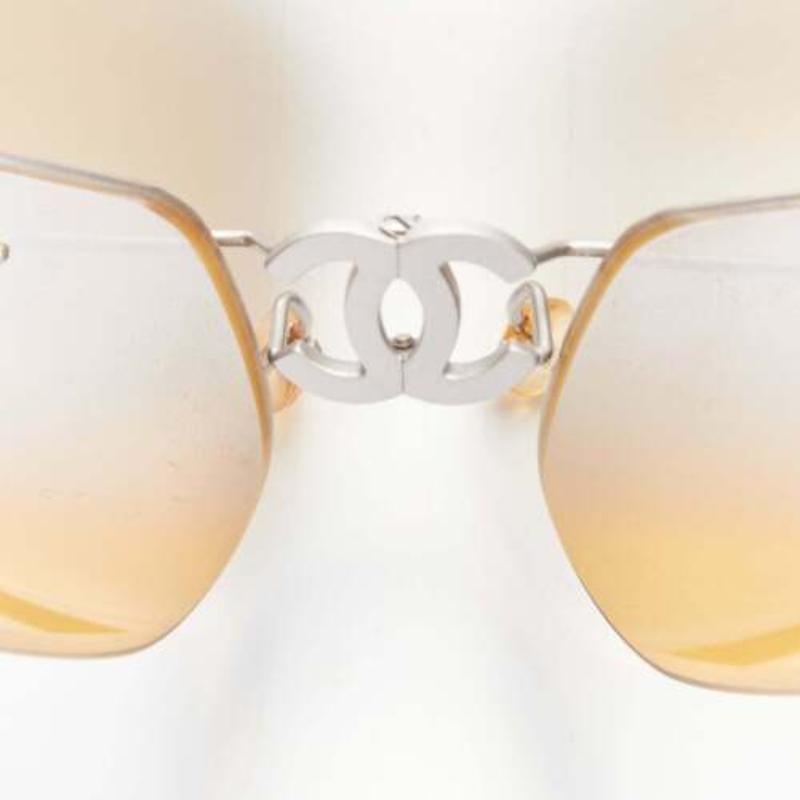 CHANEL Vintage 4040 silver CC logo yellow lens cyber folding sunglasses
Reference: KNCN/A00031
Brand: Chanel
Designer: Karl Lagerfeld
Model: 4040 Folding Lens
Material: Metal, Acrylic
Color: Yellow, Silver
Pattern: Solid
Extra Details: CC logo at