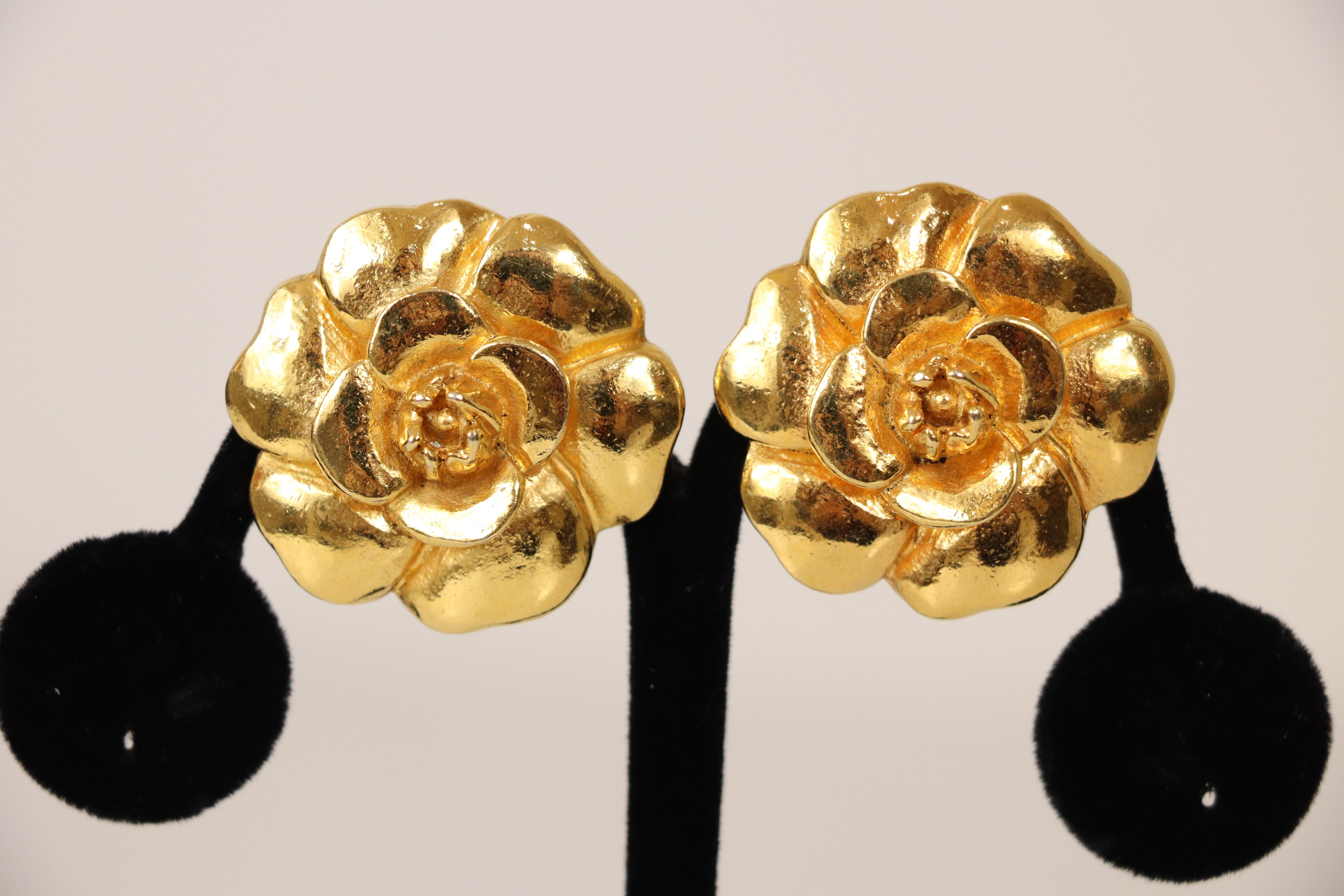 Chanel vintage earrings. 1970's era. 24k gold plated Camellia earrings with clip-on backings. Made in France. Earrings measure at 1.25