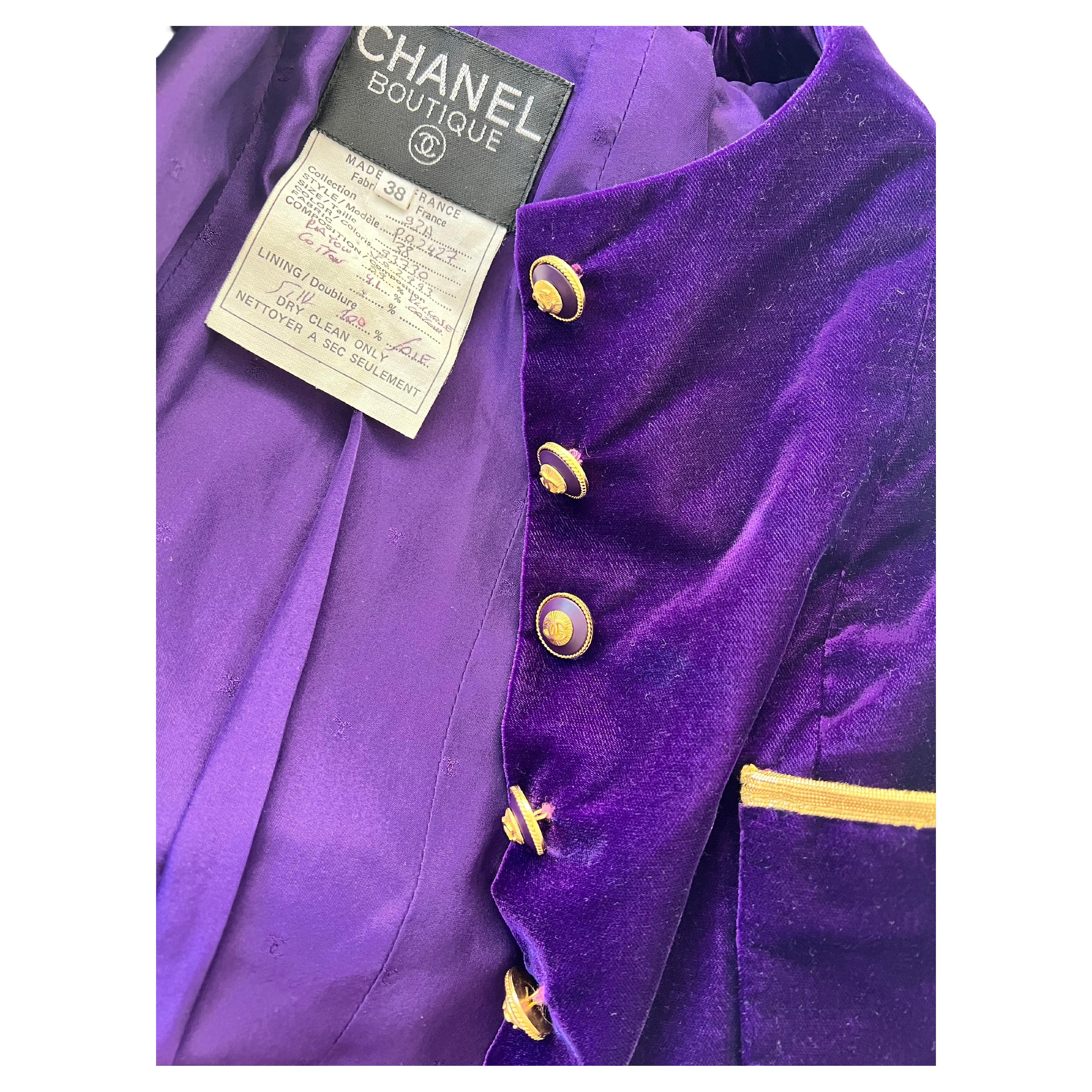 Chanel vintage 90's purple velet jacket with gold trim and Flare in the bottom, Pleats in the back.
excellent condition 

Step out in style with this stunning vintage Chanel 90's purple velvet jacket, complete with exquisite gold trim. This rare