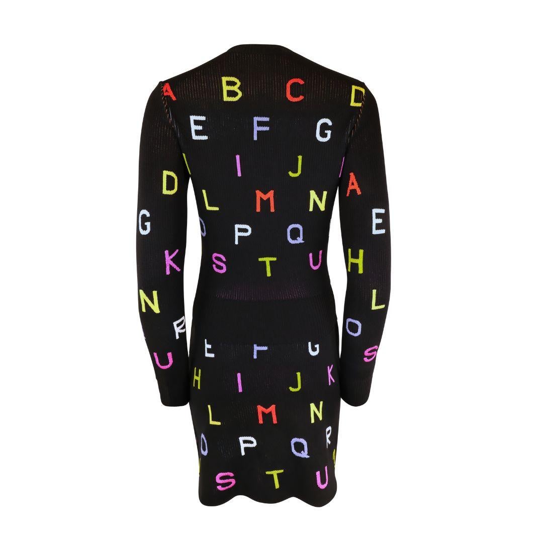 Very rare vintage Chanel knit alphabet mini sweater skirt suit from the Autumn/Winter 2001 runway collection.

Features rainbow colored alphabet letters pop against the black knit. 

The cardigan is embellished with high shine metallic, multicolor