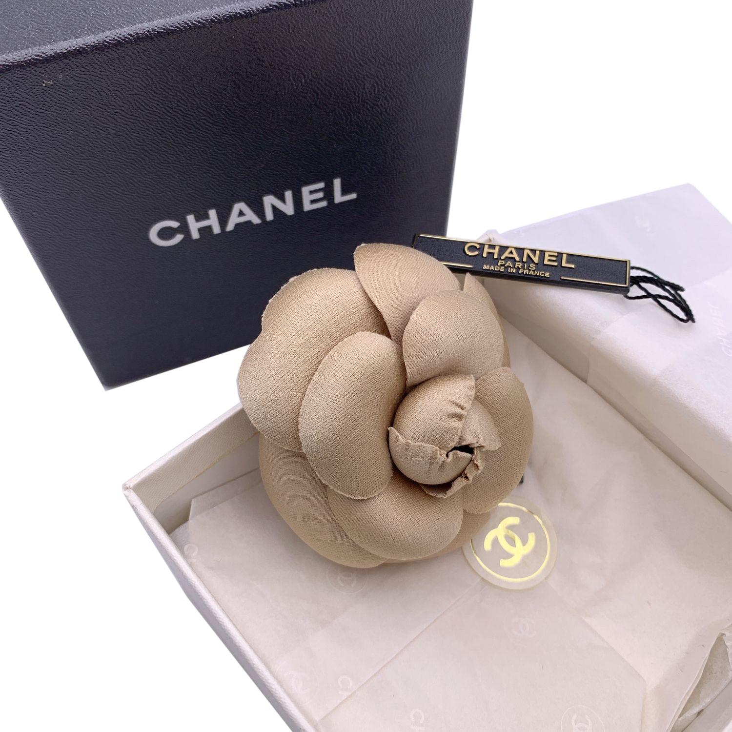 Chanel Vintage Camelia Camellia Flower Pin Brooch. Beige fabric petals. Safety pin closure. Measurements: diameter: 3 inches - 7.6 cm. 'CHANEL - CC - Made in France' oval tab on the back Condition A - EXCELLENT Gently used. Chanel box included.