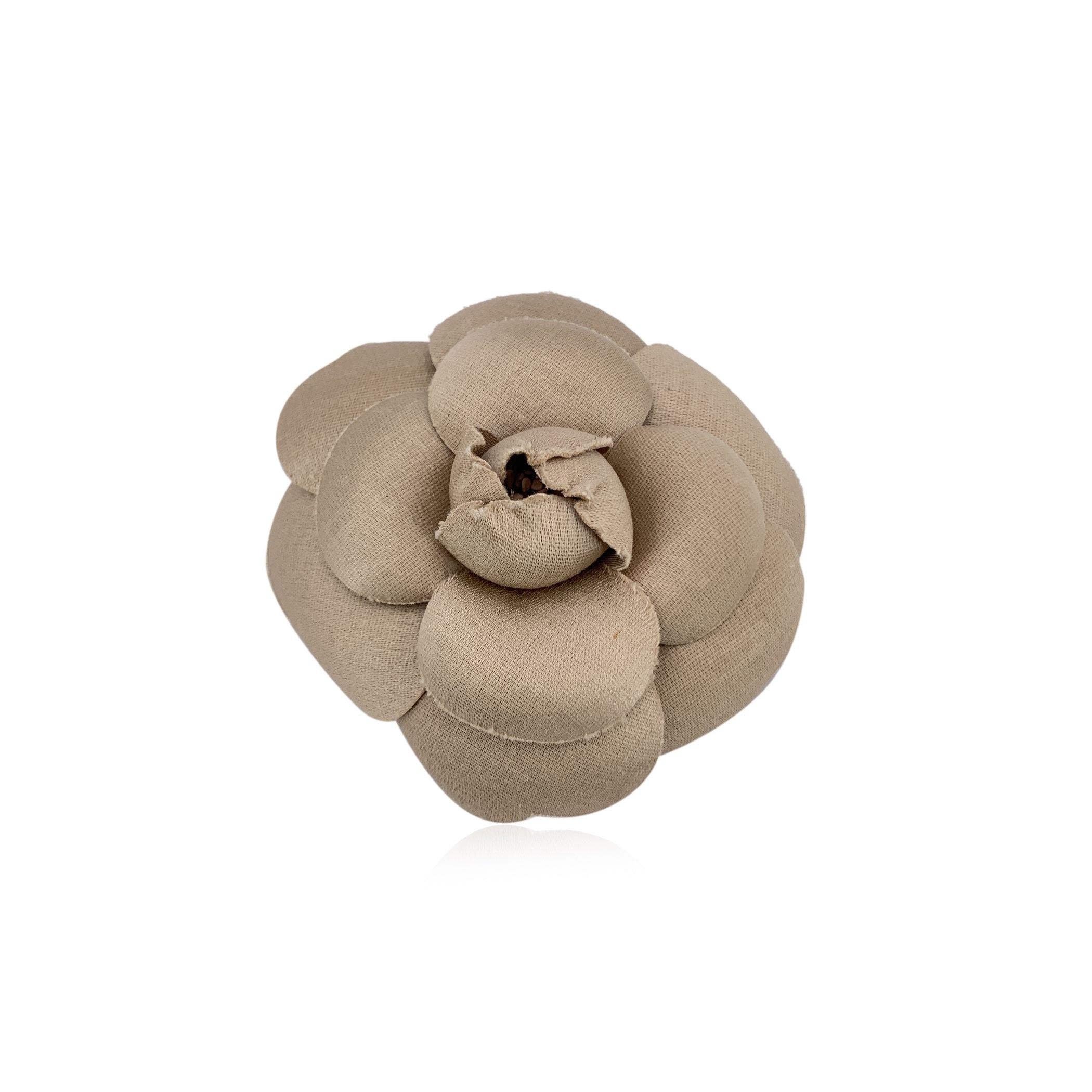 Chanel Vintage Camelia Camellia Flower Pin Brooch. Beige fabric petals. Safety pin closure. Measurements: diameter: 3 inches - 7.6 cm. 'CHANEL - CC - Made in France' oval tab on the back Condition A - EXCELLENT Gently used. Please check the photos