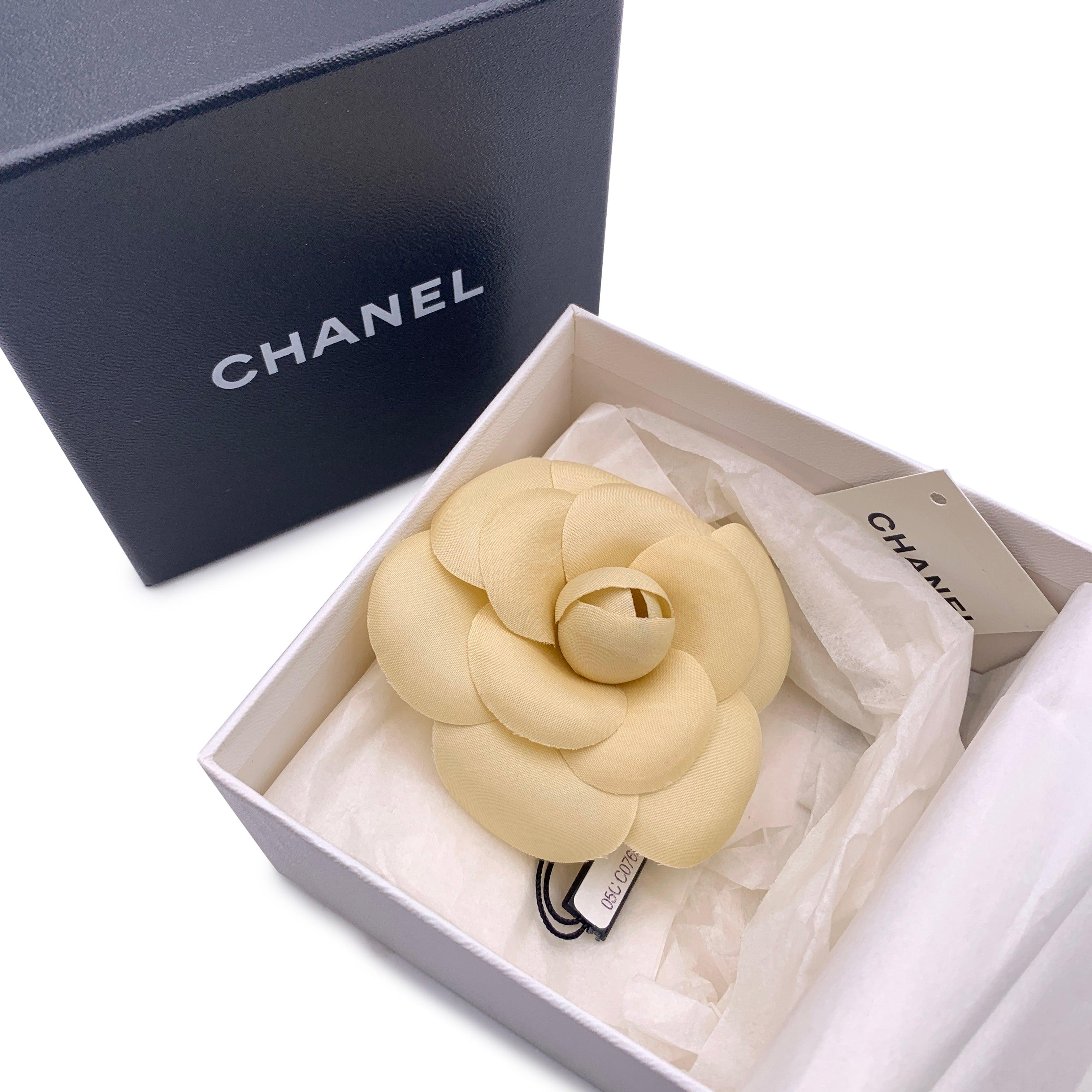 Chanel Vintage Camelia Camellia Flower Pin Brooch. Beige fabric petals. Safety pin closure. Measurements: diameter: 3.5 inches - 8.9 cm. 'CHANEL - CC - Made in France' oval tab on the back Condition A - EXCELLENT Gently used. Chanel box included.