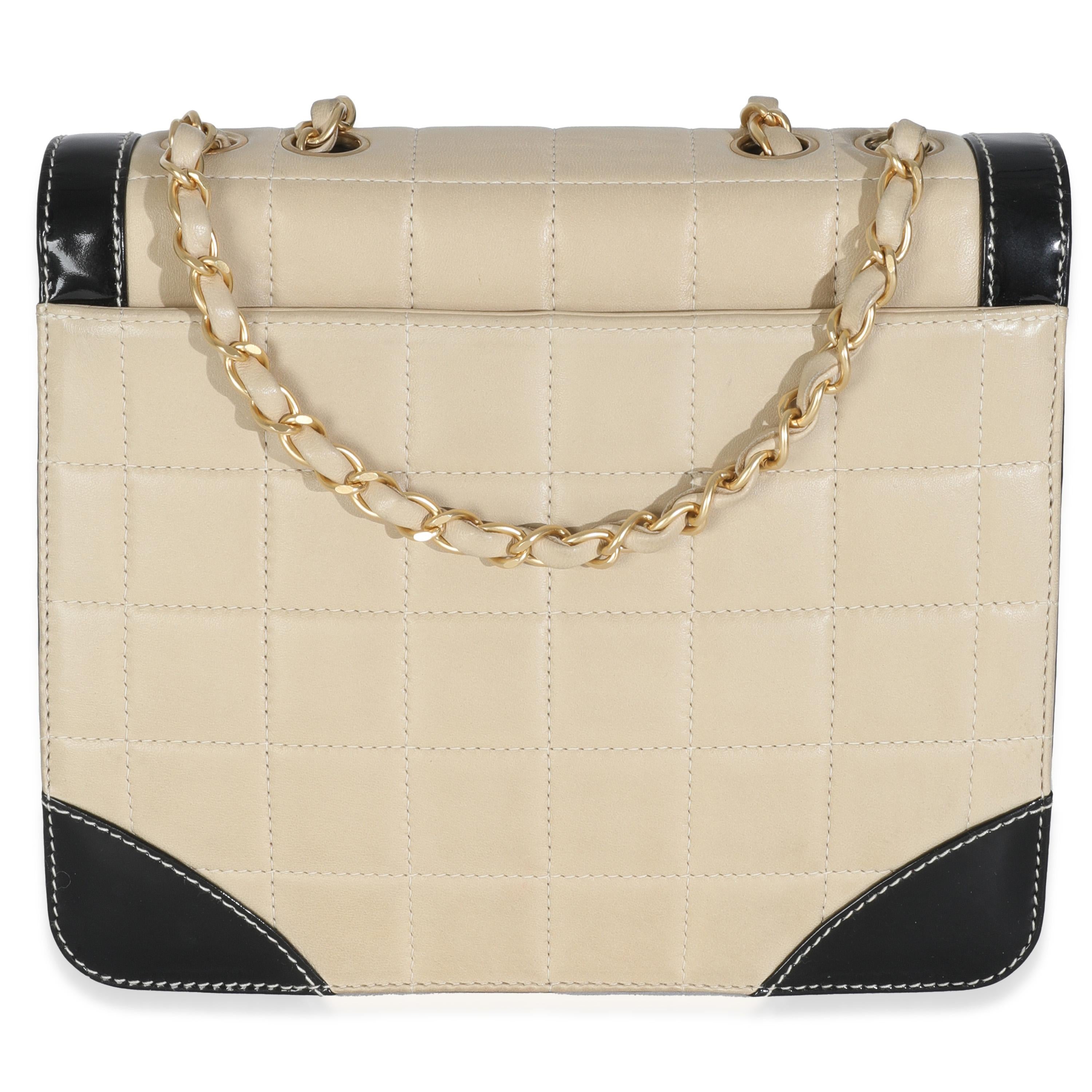 Listing Title: Chanel Vintage Beige Lambskin Black Patent Square Quilt Frame Flap Bag
SKU: 147275
Condition: Pre-owned 
Condition Description: A timeless classic that never goes out of style, the flap bag from Chanel dates back to 1955 and has seen