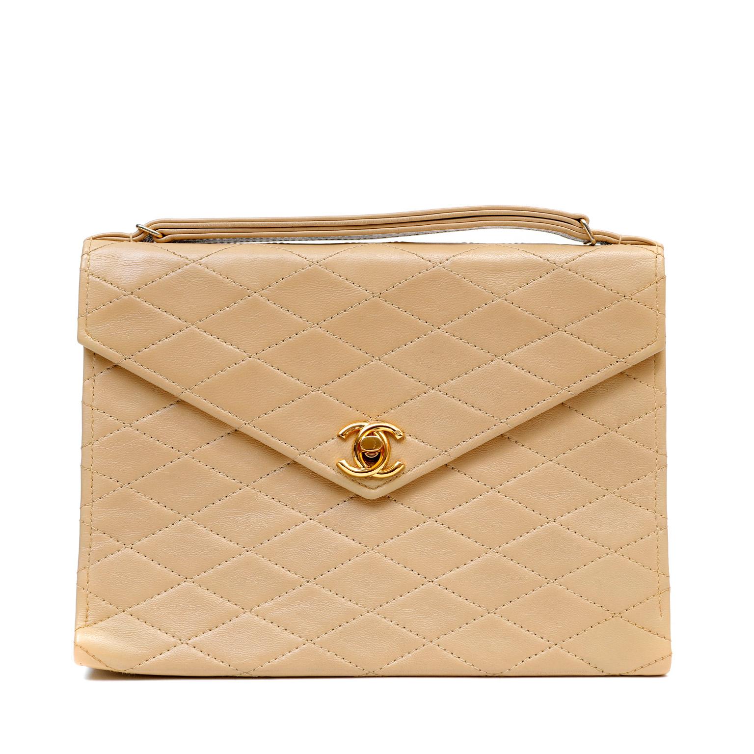 This authentic Chanel Beige Leather Vintage Envelope Flap Bag is in excellent plus condition.  An early vintage piece is rarely found as nearly pristine as this beautiful classic.  Neutral beige leather is stitched in signature Chanel diamond