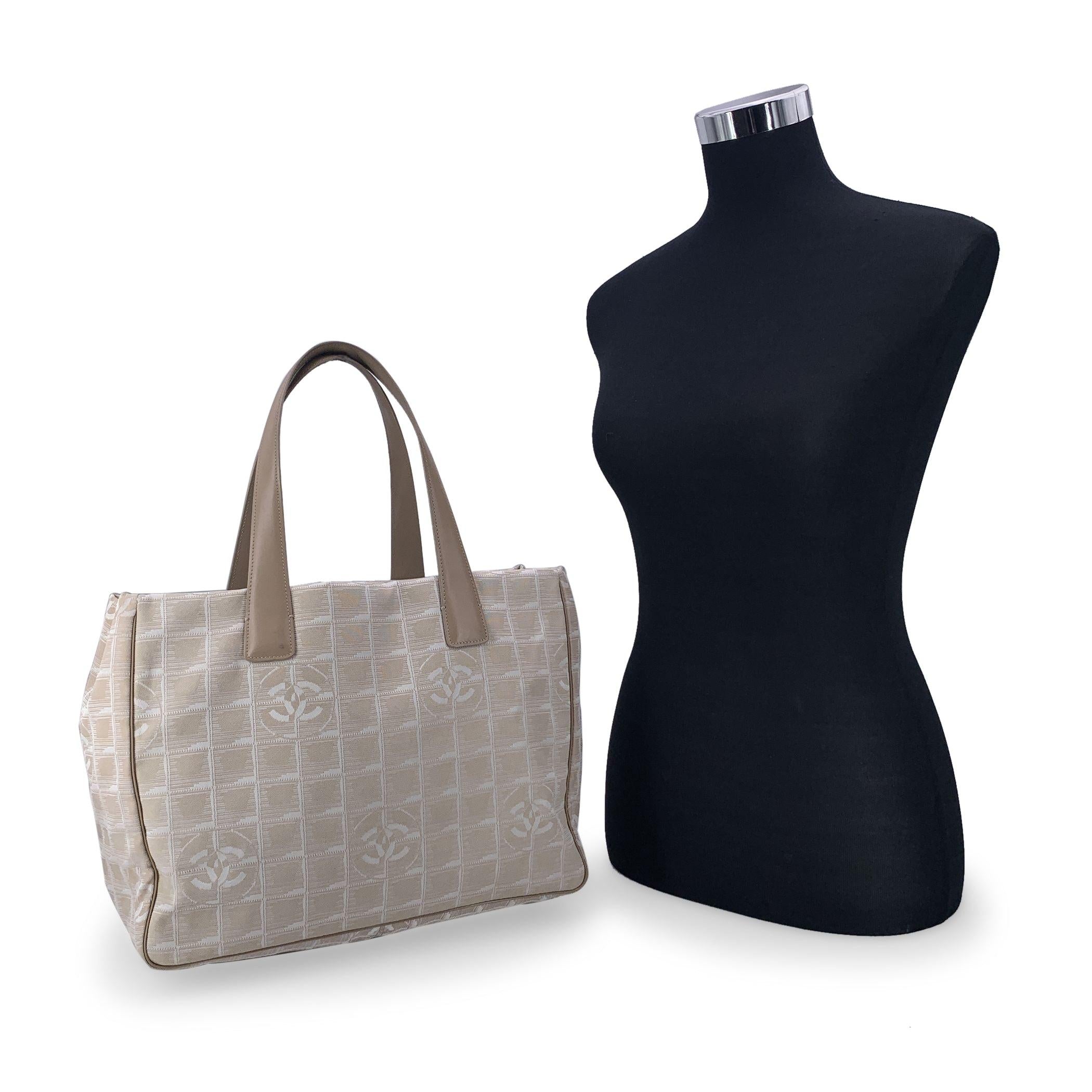 Chanel beige jacquard nylon tote bag from the 'Travel line' collection. Period/Era: 2003/2004. Beige leather top handles. Nylon lining with 2 side zip pockets inside. 'Chanel - Made in Italy' tag , authenticity hologram tag inside the bag Condition