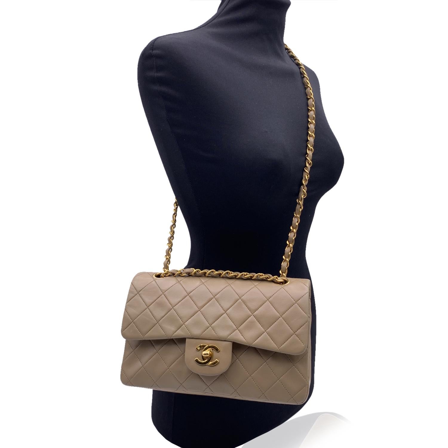 Chanel 'Timeless Classic 2.55' Quilted Double Flap 2.55 Bag in beige color. Periord/Era: 1991-1994. Features double 'CC' turn lock closure and double flap interior. 1 open pocket under the flap. Gorgeous gold metal strap with interwoven leather; can