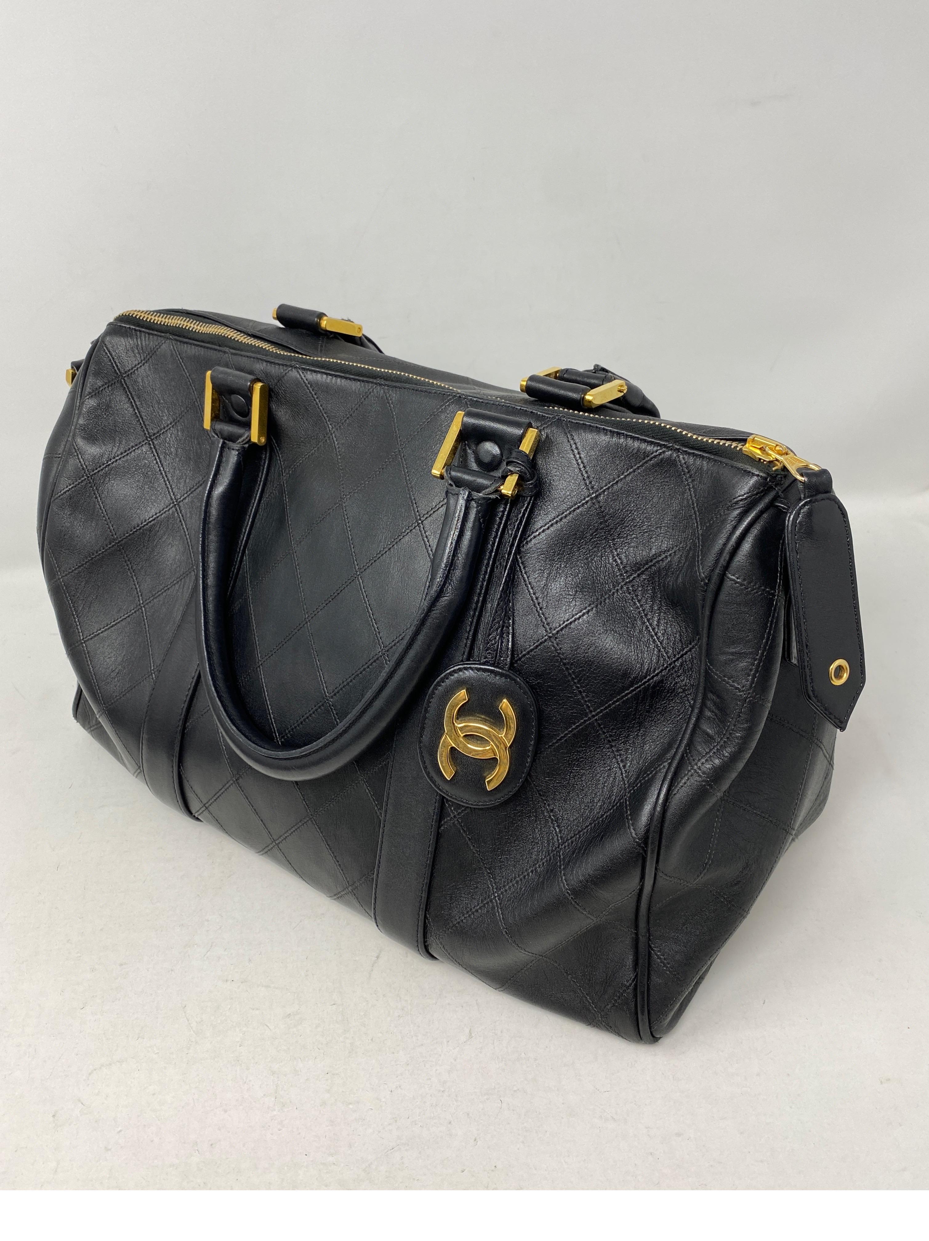 Chanel Black Vintage Boston Bag. Classic bowler or doctor's bag style by Chanel. Vintage gold plated hardware. Good condition. One side of handles has some wear. The handle is slightly bent from use. Not very noticeable. Please see all photos.