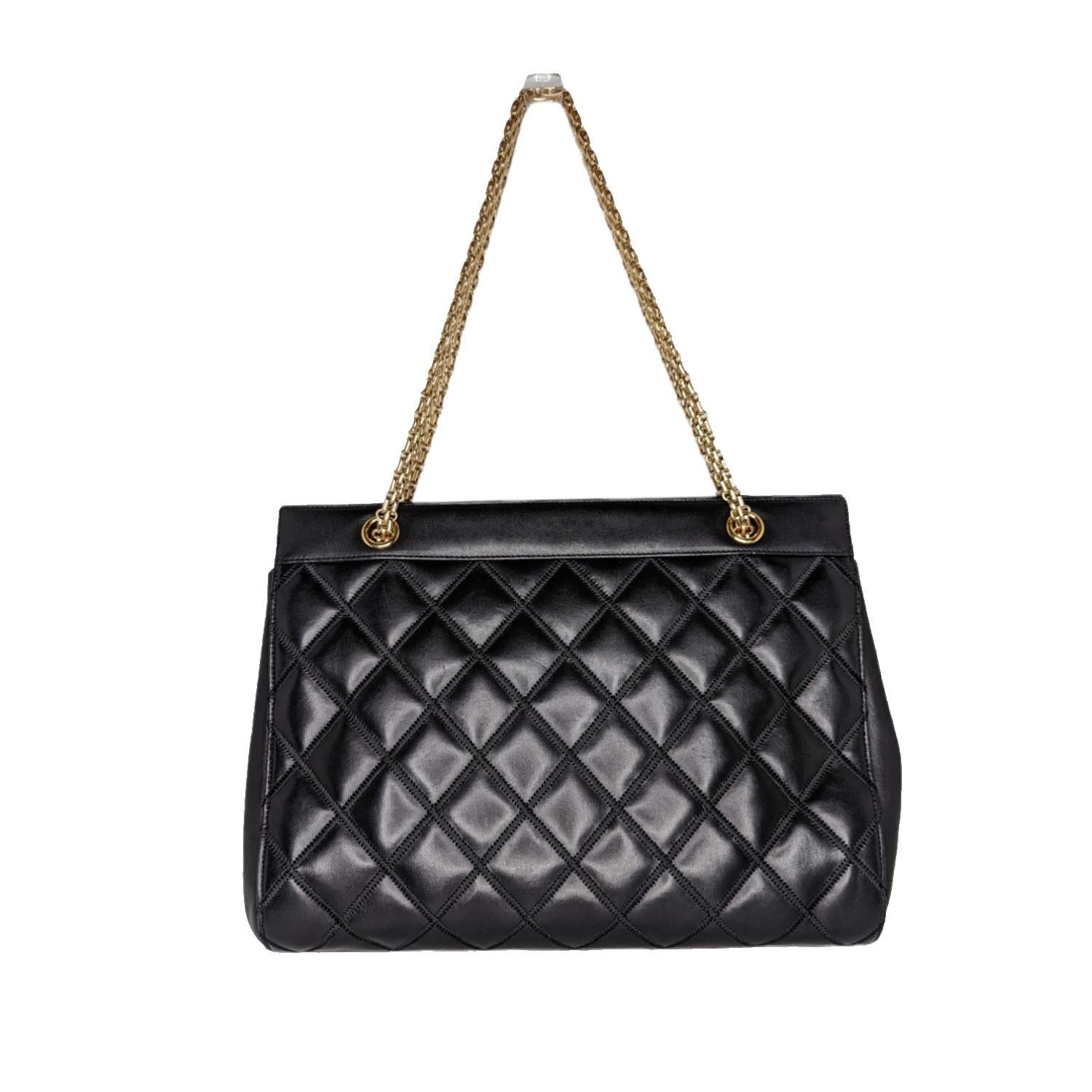 Chanel Vintage black diamond Lambskin leather tote with gold-tone hardware, Reissue chain shoulder straps, logo jacquard textile lining, three compartments, one patch and one zip pockets; magnetic closure and CC logo emblem at front.

Designer: