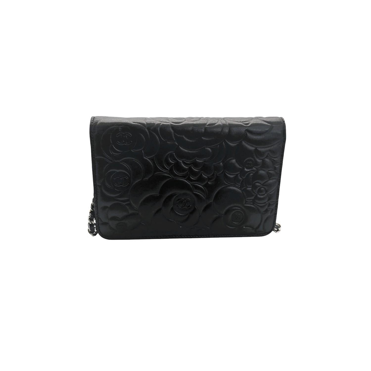 This stylish clutch wallet is finely crafted of camellia embossed black lambskin leather. The wallet features a long silver chain link shoulder strap threaded with leather and a frontal silver CC logo. The flap opens with a snap button to a light