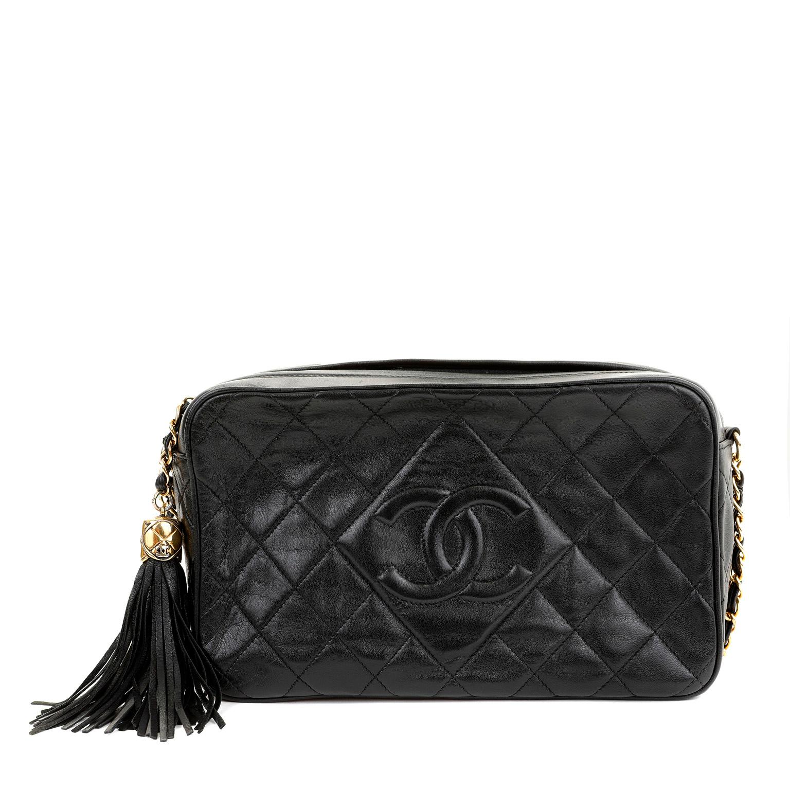 This authentic Chanel Black Lambskin Camera Bag is in good vintage condition.  Simple and elegant, the camera bag is a classic addition to any collection.  Black lambskin is quilted in signature Chanel diamond pattern.  Zippered top with oversized