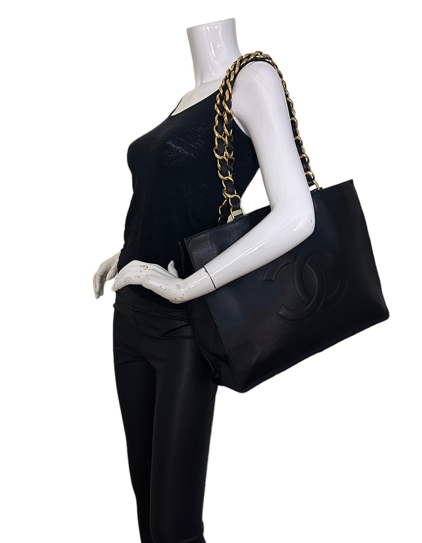 Chanel Vintage Black Leather CC Logo Tote Bag.  Features leather laced chain straps. 

Made In: France
Year of Production: 1994-1996
Color: Black
Hardware: Goldtone
Materials: Smooth lambskin leather
Lining: Leather
Closure/Opening: Open
