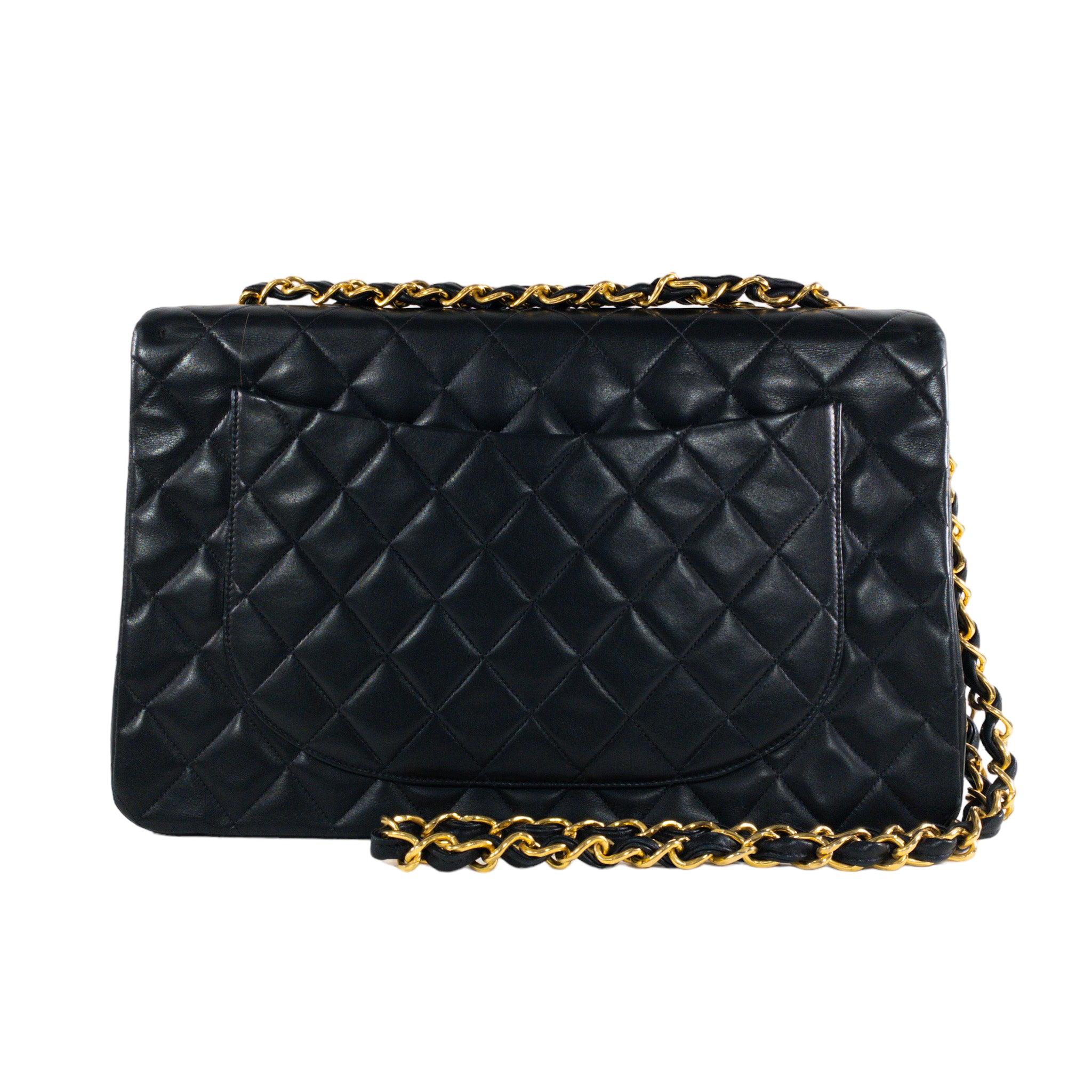 Chanel Vintage Black Lambskin Maxi Single Flap Classic Bag

This is an authentic Chanel vintage Maxi single flap. Extra large CC turn- clasp in plated gold. Quilted lambskin throughout. Sinlge flap with CC logo stitched inside. Burgundy leather