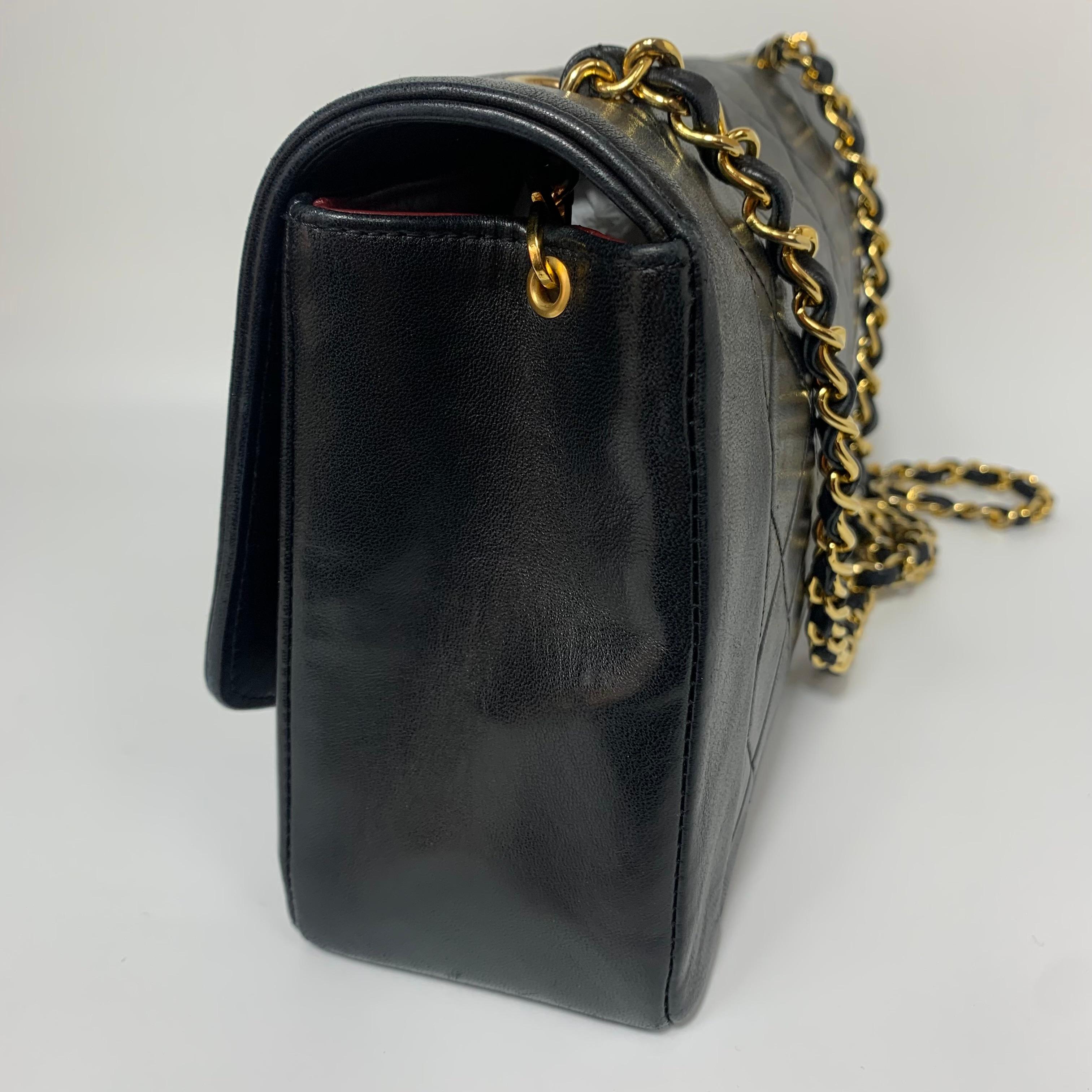 Timeless elegance meets vintage allure with this Chanel Diana Flap Bag, crafted from supple black lambskin leather. The medium size offers a perfect balance between practicality and sophistication, making it an ideal companion for day-to-night