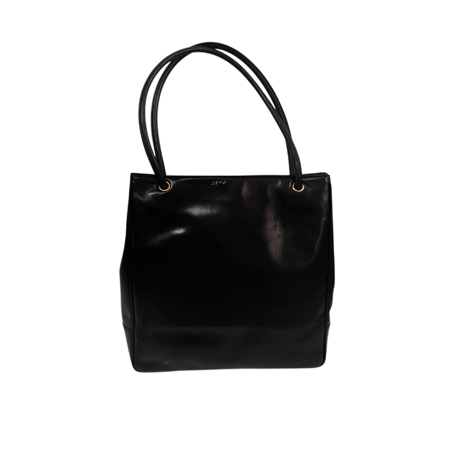 Indulge in luxury with the Chanel Vintage Timeless CC Tote. Handcrafted in Italy with smooth black lambskin leather and gold-tone hardware, this timeless tote radiates sophistication. Featuring dual rolled leather shoulder straps and a magnetic snap