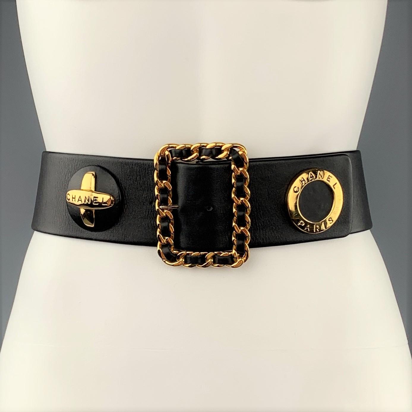 Vintage CHANEL circa Fall Winter 1993 Collection waist belt features a thick black leather strap adorned with oversized gold tone ornament studs and a woven chain buckle.  Made in France.
 
Excellent Pre-Owned Condition.
Marked: 70/28  93 A
