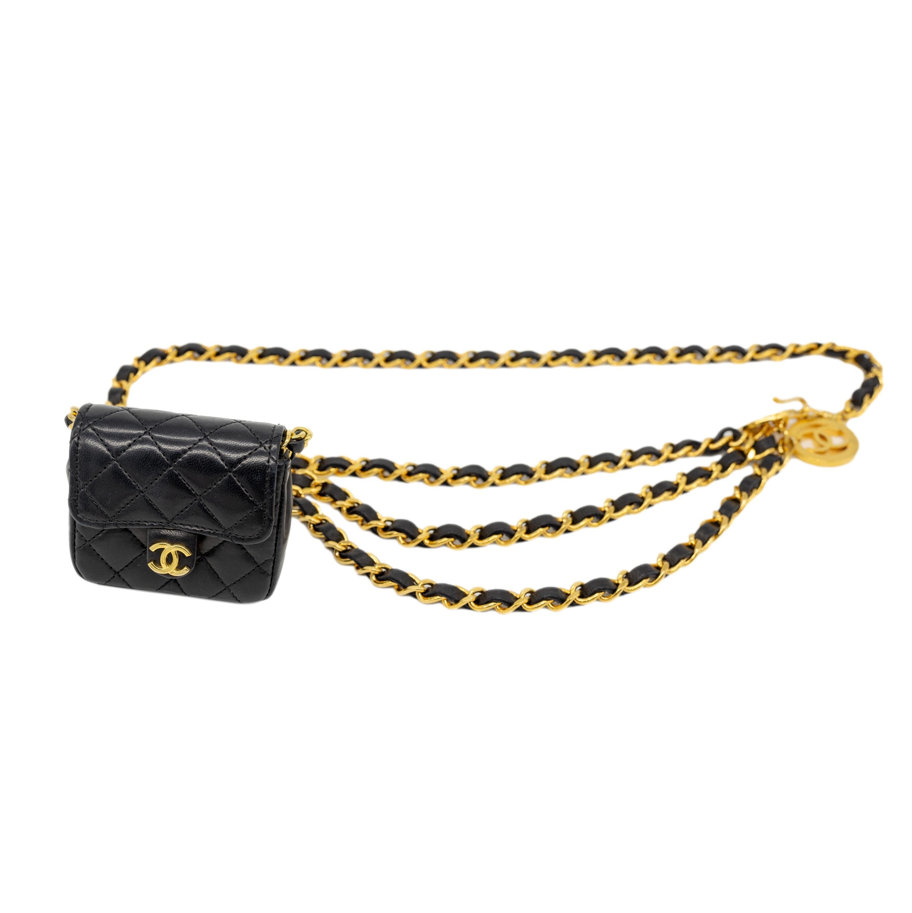 Chanel Vintage Black Leather Detachable Micro Flap Bag on 24KT Gold Triple Swag Medallion Belt, 1984. The iconic Chanel bag was originally issued by Coco Chanel in February 1955 which became the very first socially acceptable shoulder bag for the