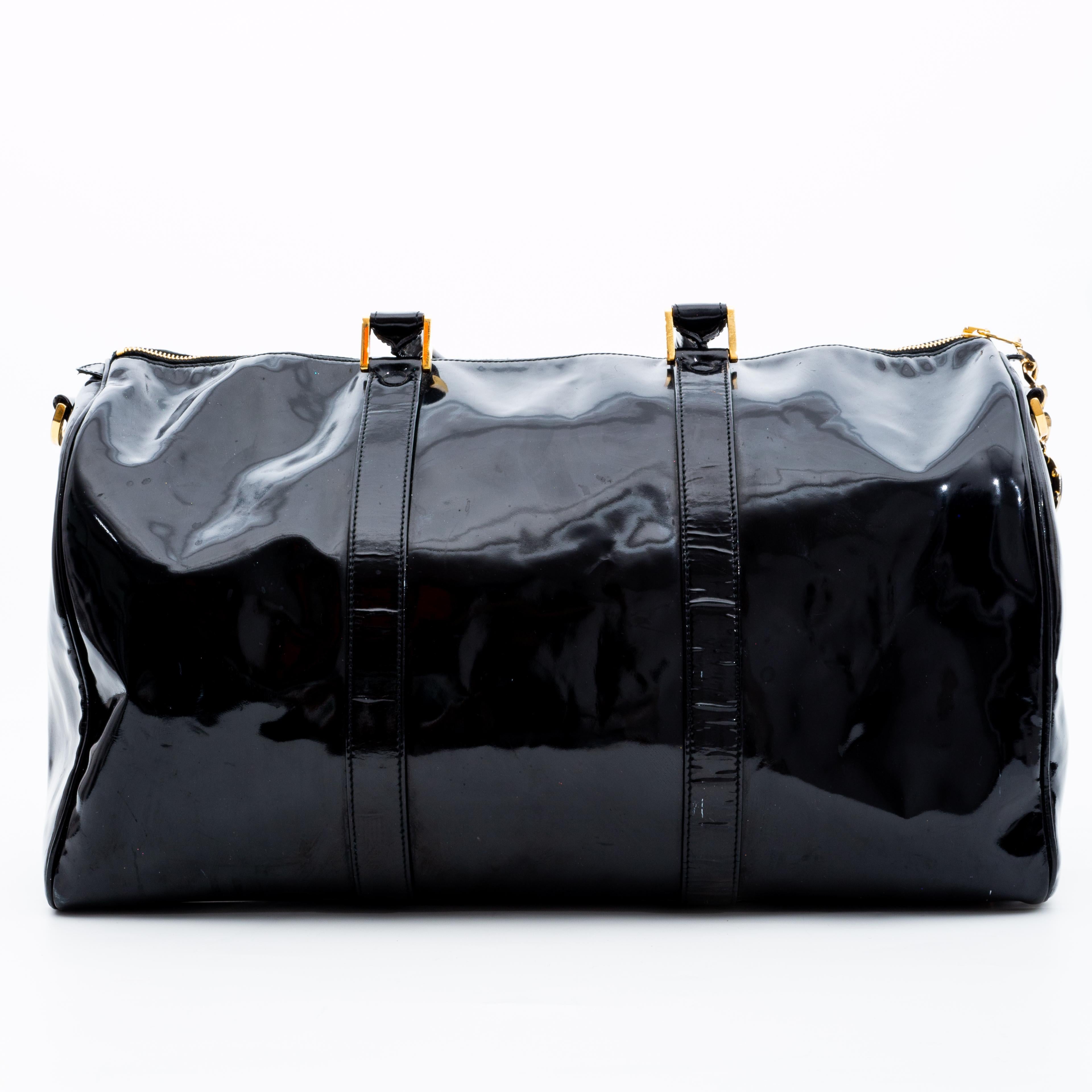 A classic Bowler bag made in the bold and statement black patent leather, this Chanel bag is everything that is highly functional and also extremely stylish. With a gold-tone top zipper closure and a classic bowler shape, this bag provides ample
