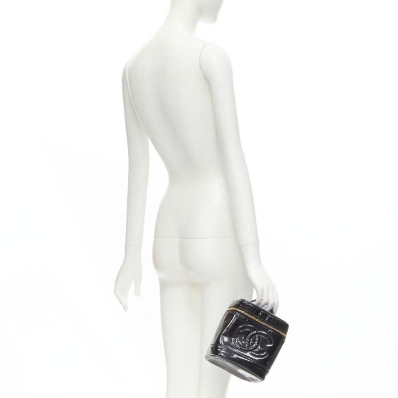 CHANEL Vintage black patent leather CC logo top handle Vanity bag
Reference: KNCN/A00028
Brand: Chanel
Designer: Karl Lagerfeld
Model: Vanity bag
Material: Patent Leather
Color: Black
Pattern: Solid
Closure: Zip
Lining:  Leather
Extra Details: CC