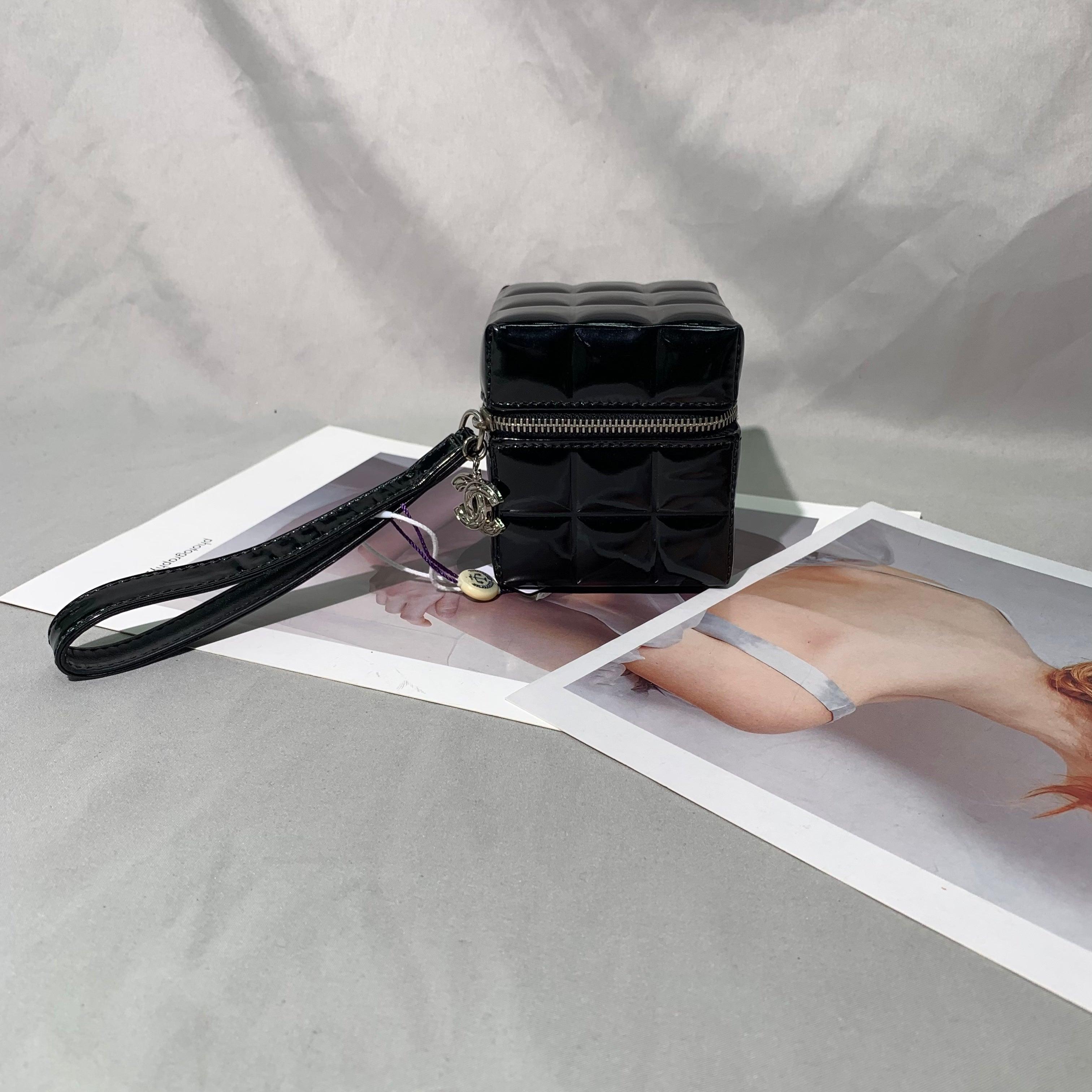 Chanel Vintage Black Patent Leather Micro Quilt Cube Wristlet Bag, 2002-2003
  These are professional photos of the actual bag offered by Luxbags.
  This elegant Chanel Vintage Black Patent Leather Micro Quilt Cube Wristlet Bag features a small