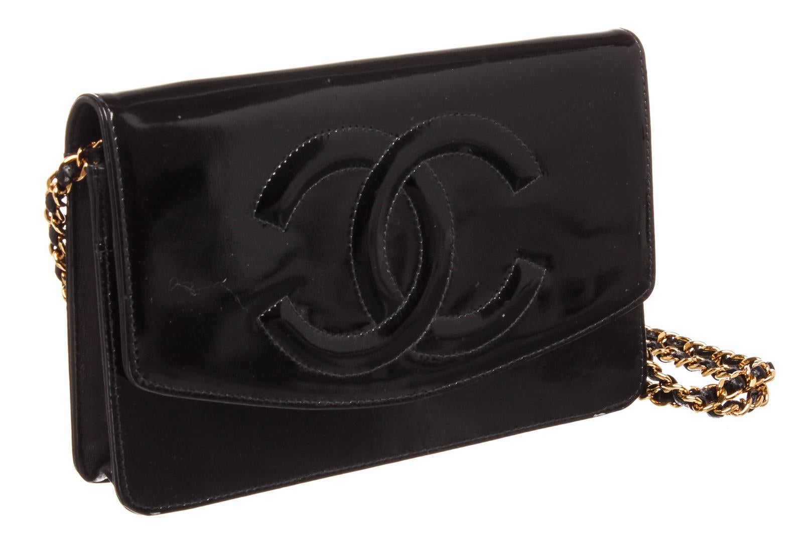 Black patent leather Chanel vintage wallet on chain with gold-tone hardware, single chain-link and leather shoulder strap, exterior zip pocket at back, top-stitched CC accent at front, black leather interior, three interior compartments; one with