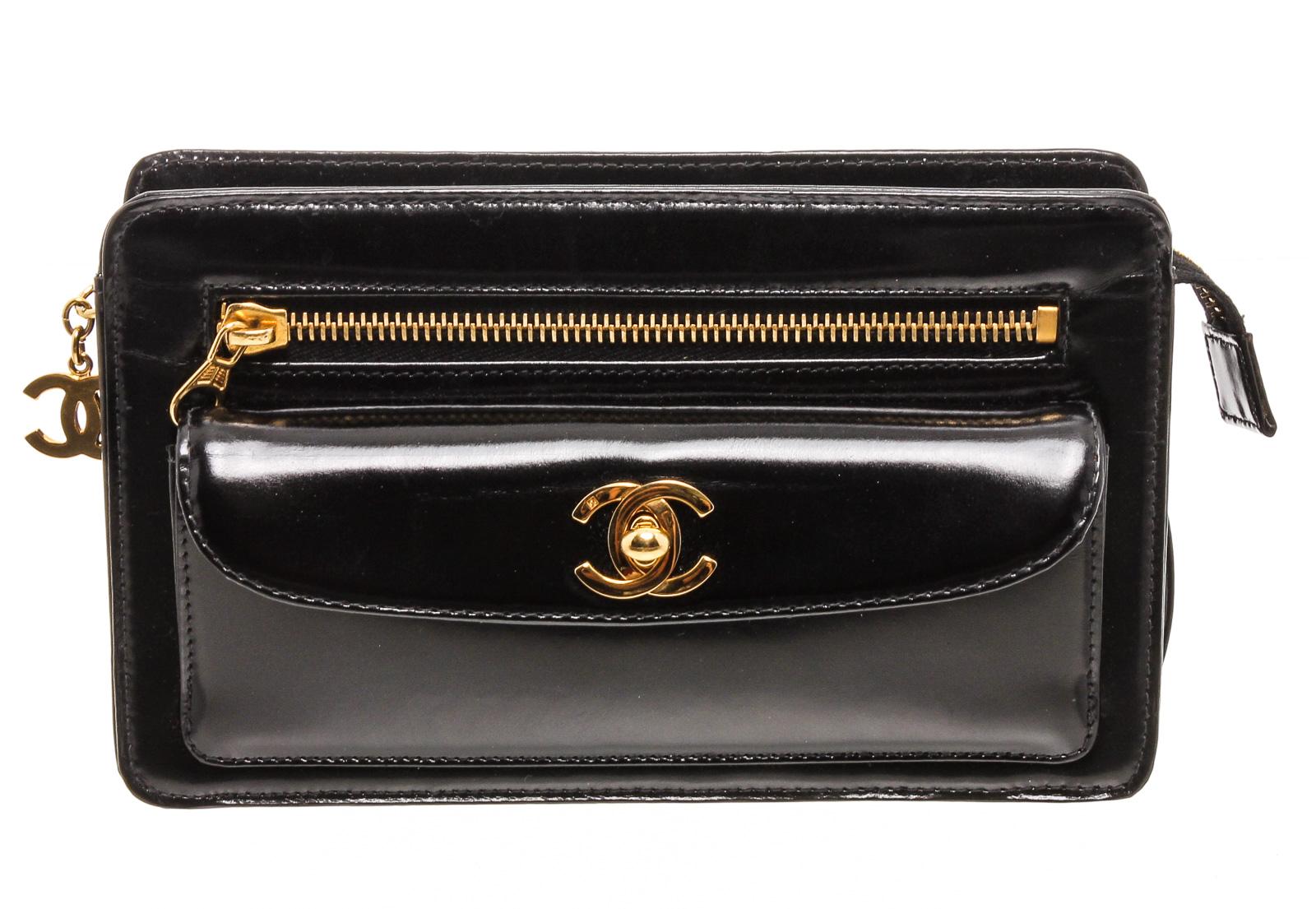 Black patent leather Chanel vintage wristlet clutch with gold-tone hardware, three exterior pockets; one with CC turn-lock closure, burgundy leather lining, one slip pocket at interior wall and overall zip closure with CC zip adornment. 

16270MSC