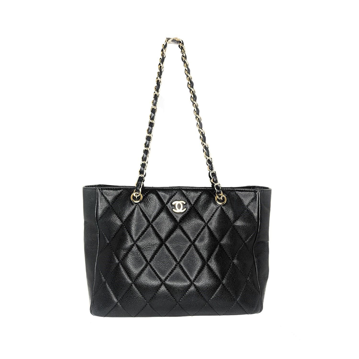 Vintage black quilted Caviar leather Chanel Timeless Classic tote with gold-tone hardware, dual leather woven chain-link shoulder straps, tonal leather lining, two pockets at interior wall; one with zip closure and CC logo emblem at front. Includes