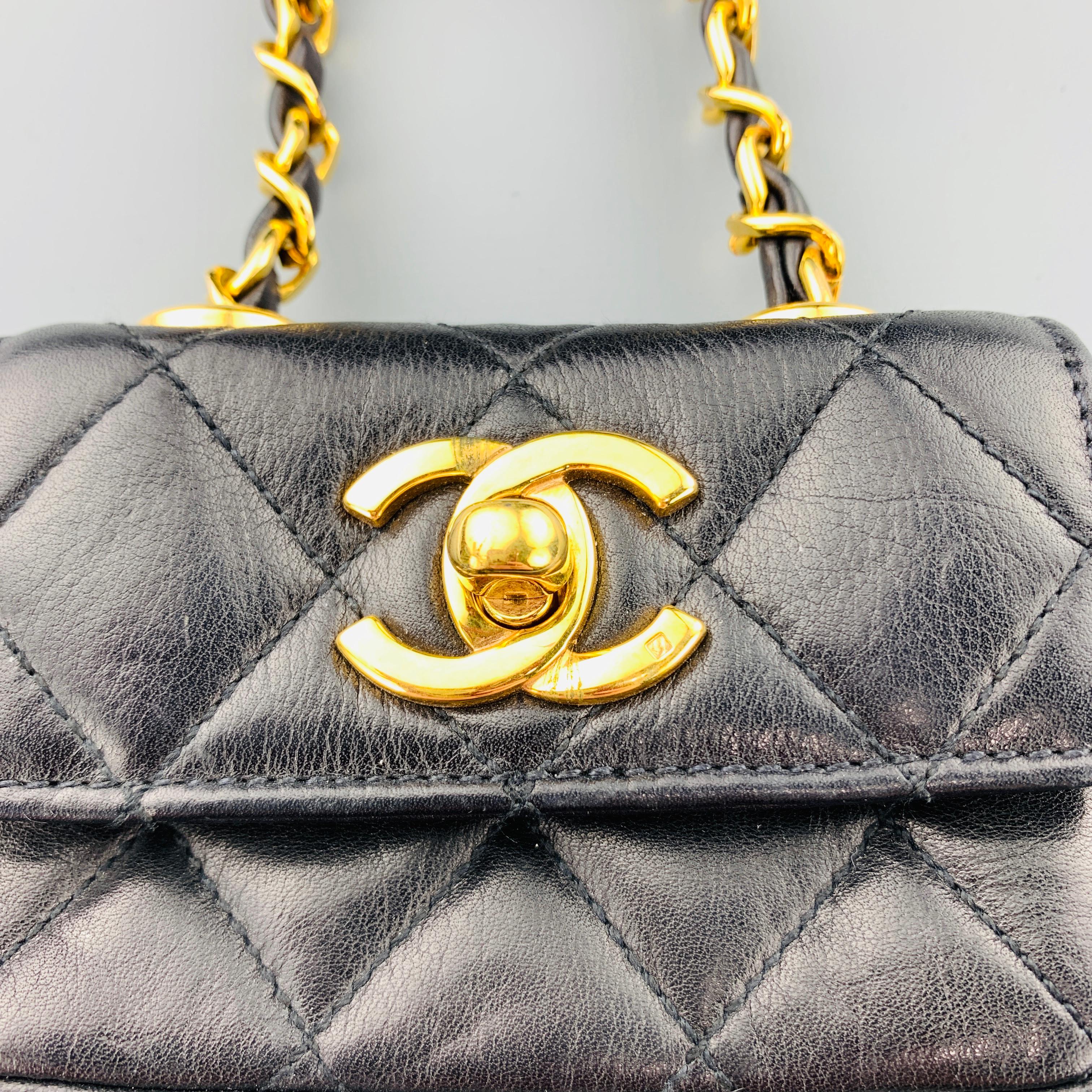 Vintage CHANEL mini purse coin pouch comes in black quilted leather with a flap top, yellow gold tone CC logo turn lock closure, and leather woven chain with Belt loop. Minor wear. Made in Italy.
 
Very Good Pre-Owned Condition.
Marked: 2300502
