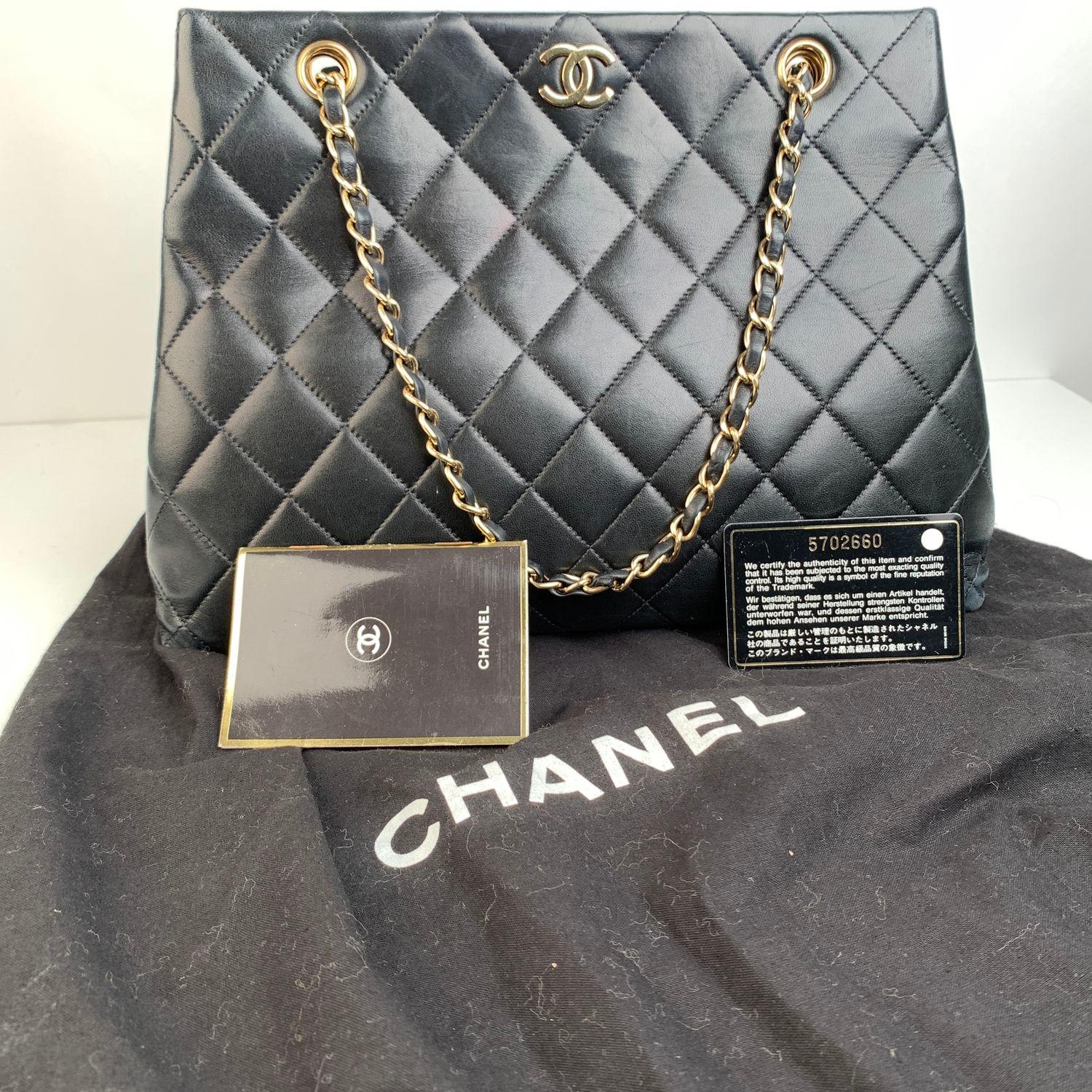 Sophisticated black quilted leather shoulder bag by CHANEL with double gold metal chain and interwoven leather shoulder straps. Gold metal CC - CHANEL logo on the front. The bag features upper magnetic button closure, leather lining, 1 side zip