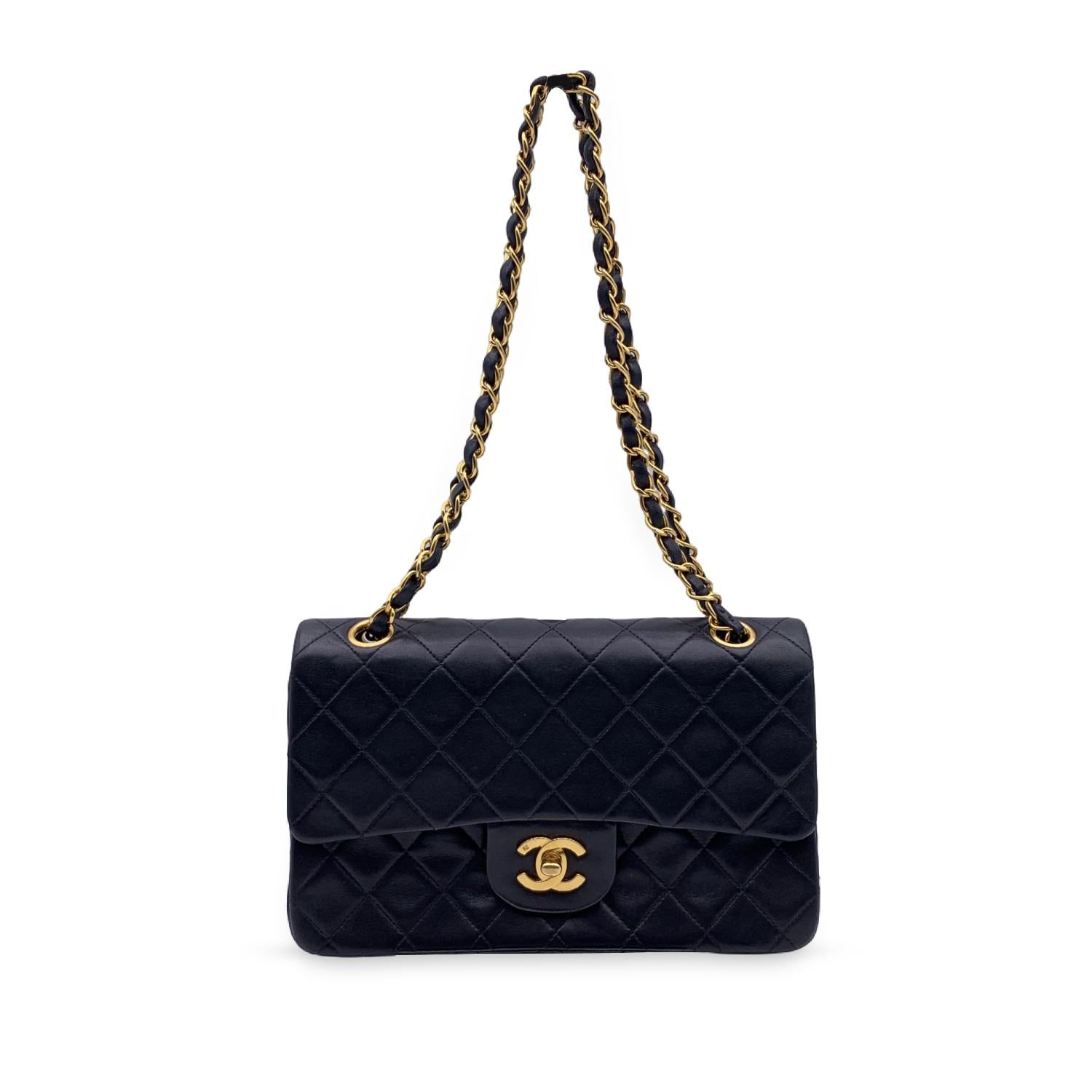 Chanel 'Timeless Classic 2.55' Quilted Double Flap 2.55 Bag in Black color. Periord/Era: 1997-1999 Features double 'CC' turn lock closure and double flap interior. 1 open pocket under the flap. Gorgeous gold metal strap with interwoven leather; can